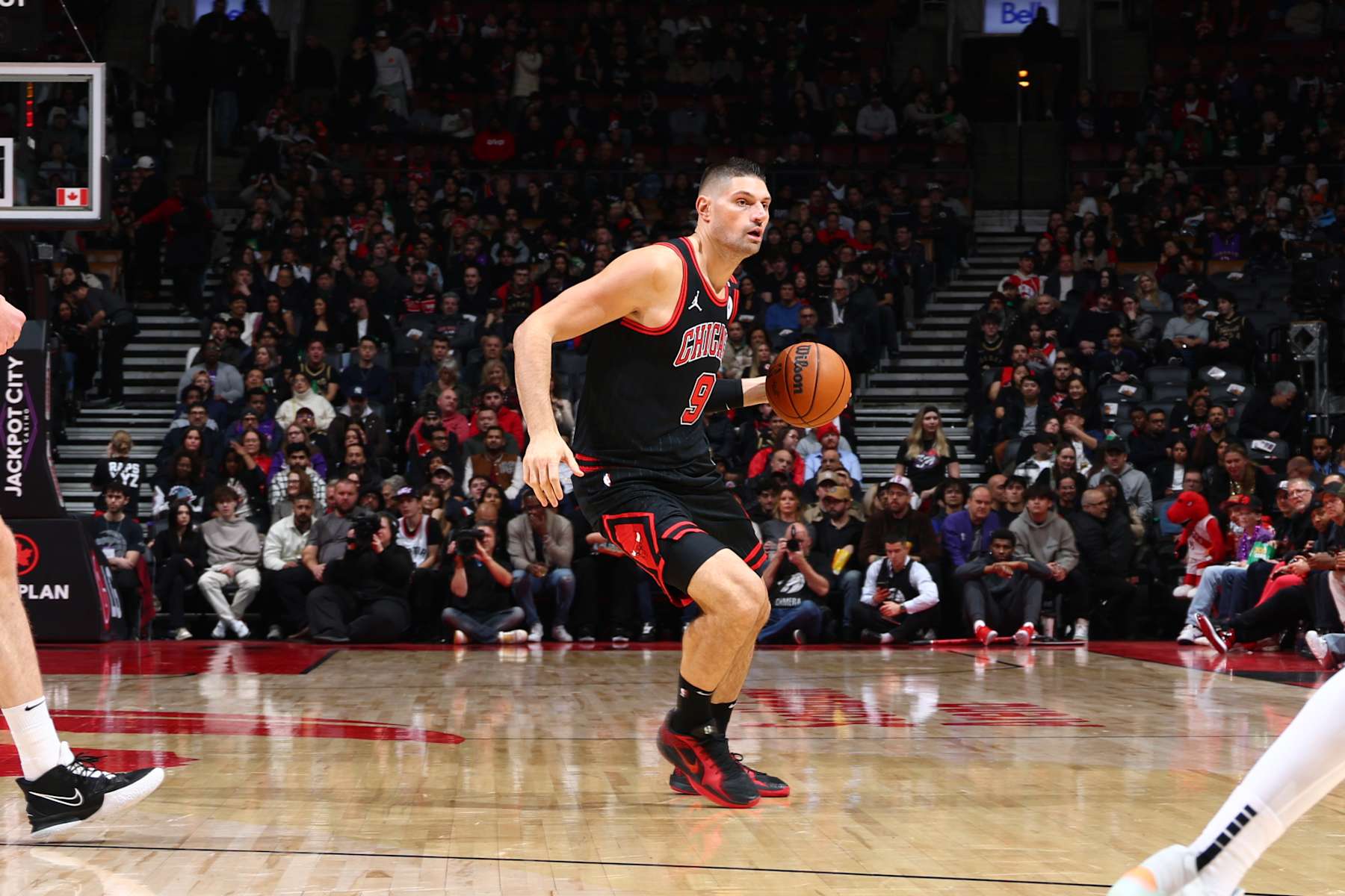 TORONTO, CANADA - DECEMBER 16:  Nikola Vucevic #9 of the Chicago Bulls handles the ball during the game against the Toronto Raptors on December 16, 2024 at the Scotiabank Arena in Toronto, Ontario, Canada.  NOTE TO USER: User expressly acknowledges and agrees that, by downloading and or using this Photograph, user is consenting to the terms and conditions of the Getty Images License Agreement.  Mandatory Copyright Notice: Copyright 2024 NBAE (Photo by Vaughn Ridley/NBAE via Getty Images)