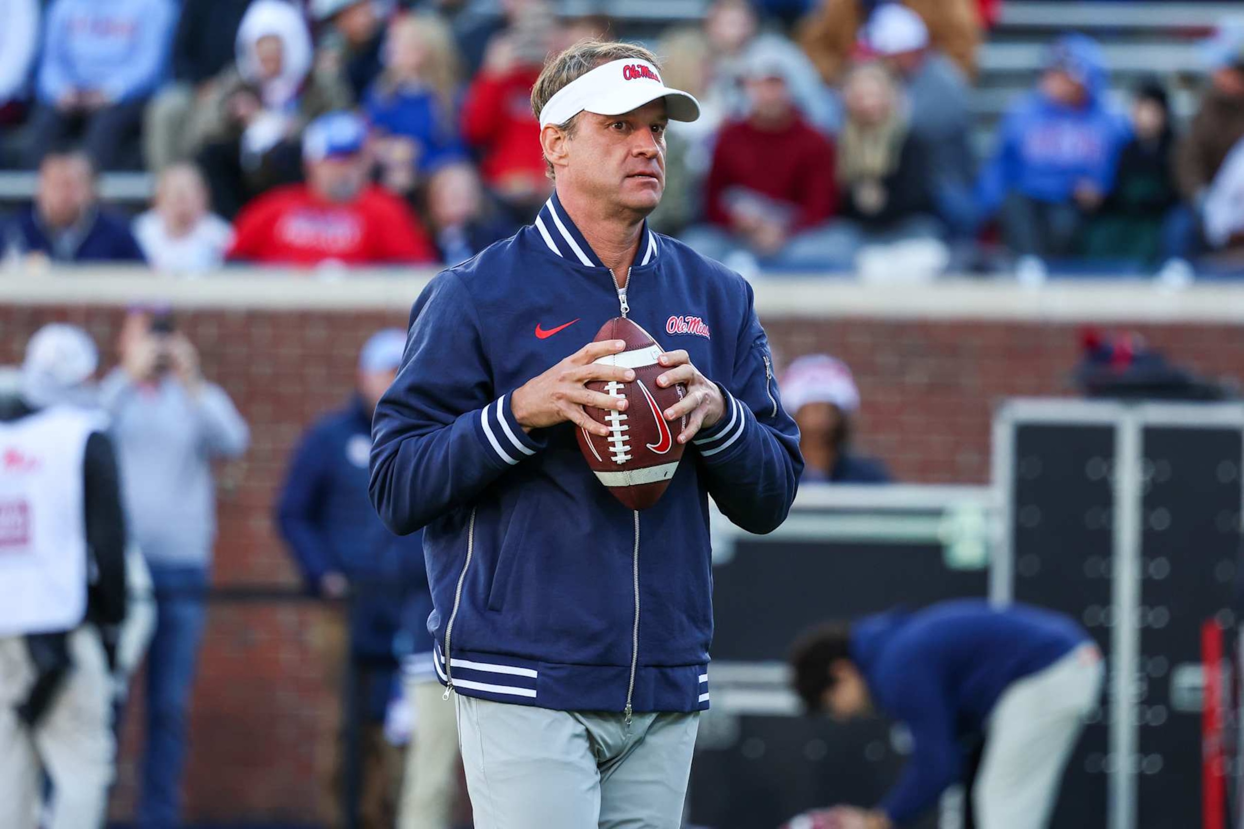 OXFORD, MISSISSIPPI - NOVEMBER 29: Lane Kiffin head coach of the Mississippi Rebels looks on during warm ups prior to the game against the Mississippi State Bulldogs at Vaught-Hemingway Stadium on November 29, 2024 in Oxford, Mississippi. (Photo by Wes Hale/Getty Images) OXFORD, MISSISSIPPI - NOVEMBER 29: Lane Kiffin head coach of the Mississippi Rebels looks on during warm ups prior to the game against the Mississippi State Bulldogs at Vaught-Hemingway Stadium on November 29, 2024 in Oxford, Mississippi. (Photo by Wes Hale/Getty Images)