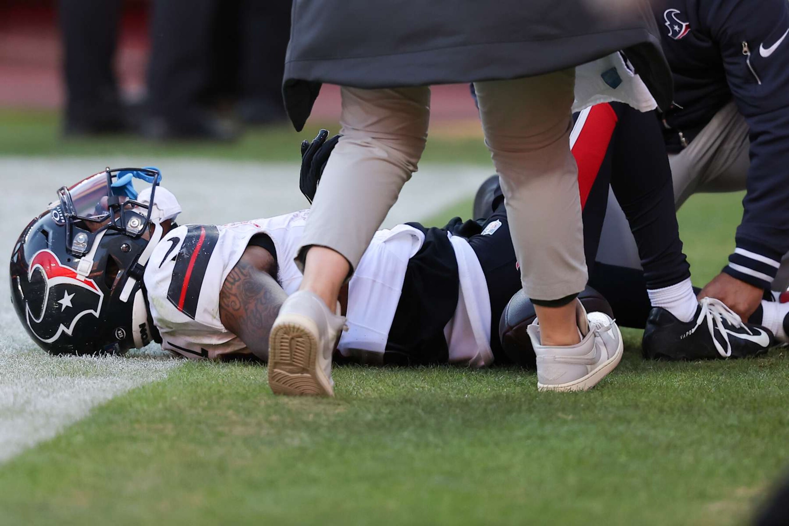 KANSAS CITY, MISSOURI - DECEMBER 21: Medical staff look at Tank Dell #3 of the Houston Texans after Dell sustained an injury while catching a touchdown in the third quarter of a game against the Kansas City Chiefs at GEHA Field at Arrowhead Stadium on December 21, 2024 in Kansas City, Missouri. (Photo by David Eulitt/Getty Images)