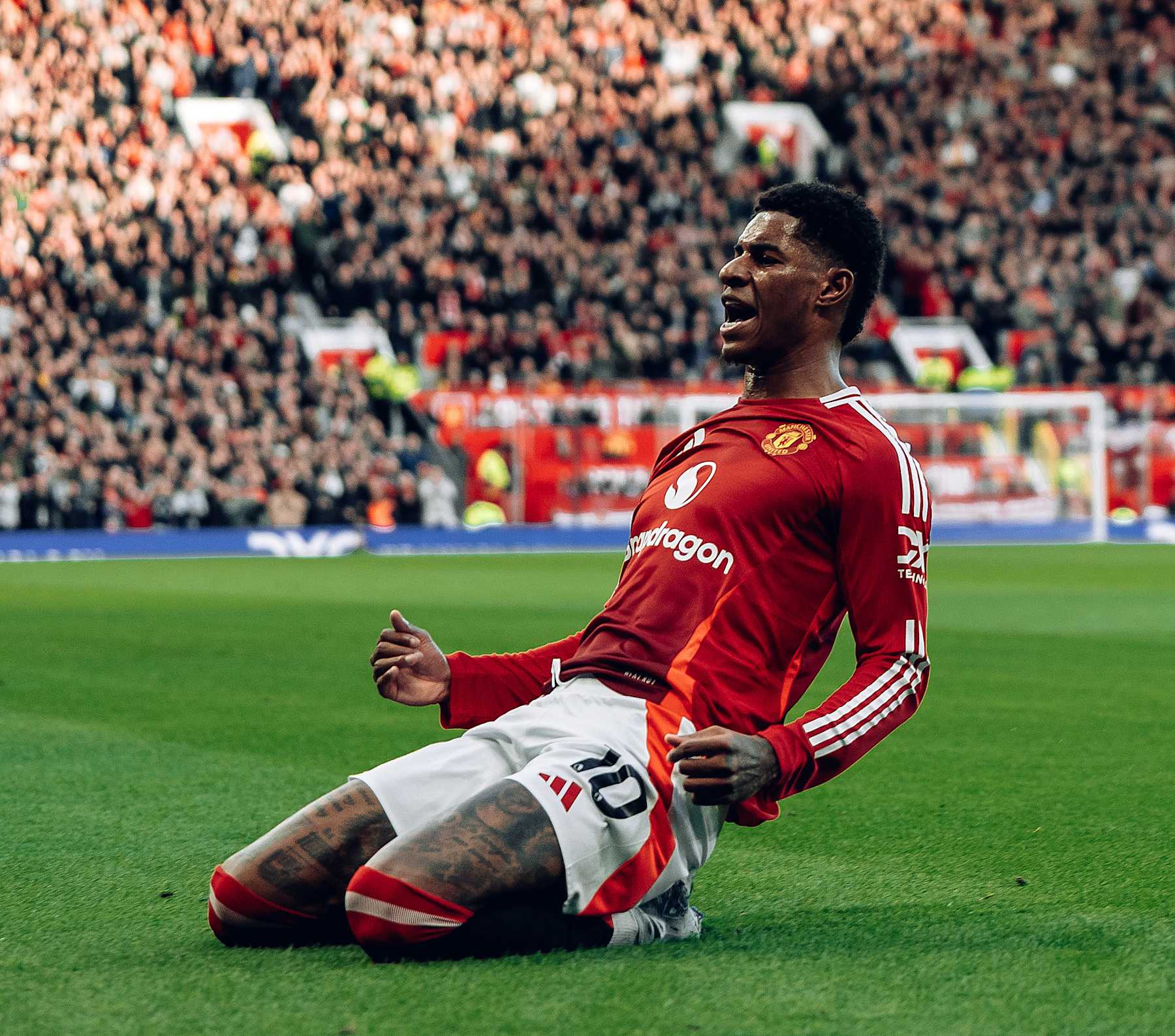 MANCHESTER, ENGLAND - DECEMBER 01: Marcus Rashford of Manchester United celebrates Jarrad Branthwaite of Everton scoring an own goal during the Premier League match between Manchester United FC and Everton FC at Old Trafford on December 01, 2024 in Manchester, England. (Photo by Zohaib Alam - MUFC/Manchester United via Getty Images)