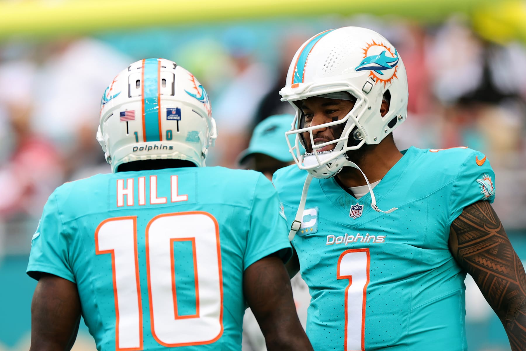 MIAMI GARDENS, FLORIDA - DECEMBER 22: Tyreek Hill #10 of the Miami Dolphins talks with teammate Tua Tagovailoa #1 before playing the San Francisco 49ers at Hard Rock Stadium on December 22, 2024 in Miami Gardens, Florida. (Photo by Carmen Mandato/Getty Images)