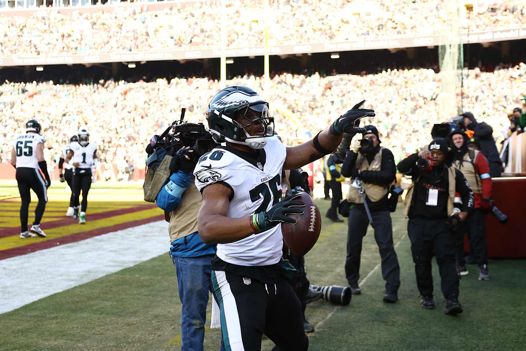 LANDOVER, MARYLAND - DECEMBER 22: Saquon Barkley #26 of the Philadelphia Eagles celebrates after scoring a rushing touchdown against the Washington Commanders during the first quarter at Northwest Stadium on December 22, 2024 in Landover, Maryland. (Photo by Timothy Nwachukwu/Getty Images)