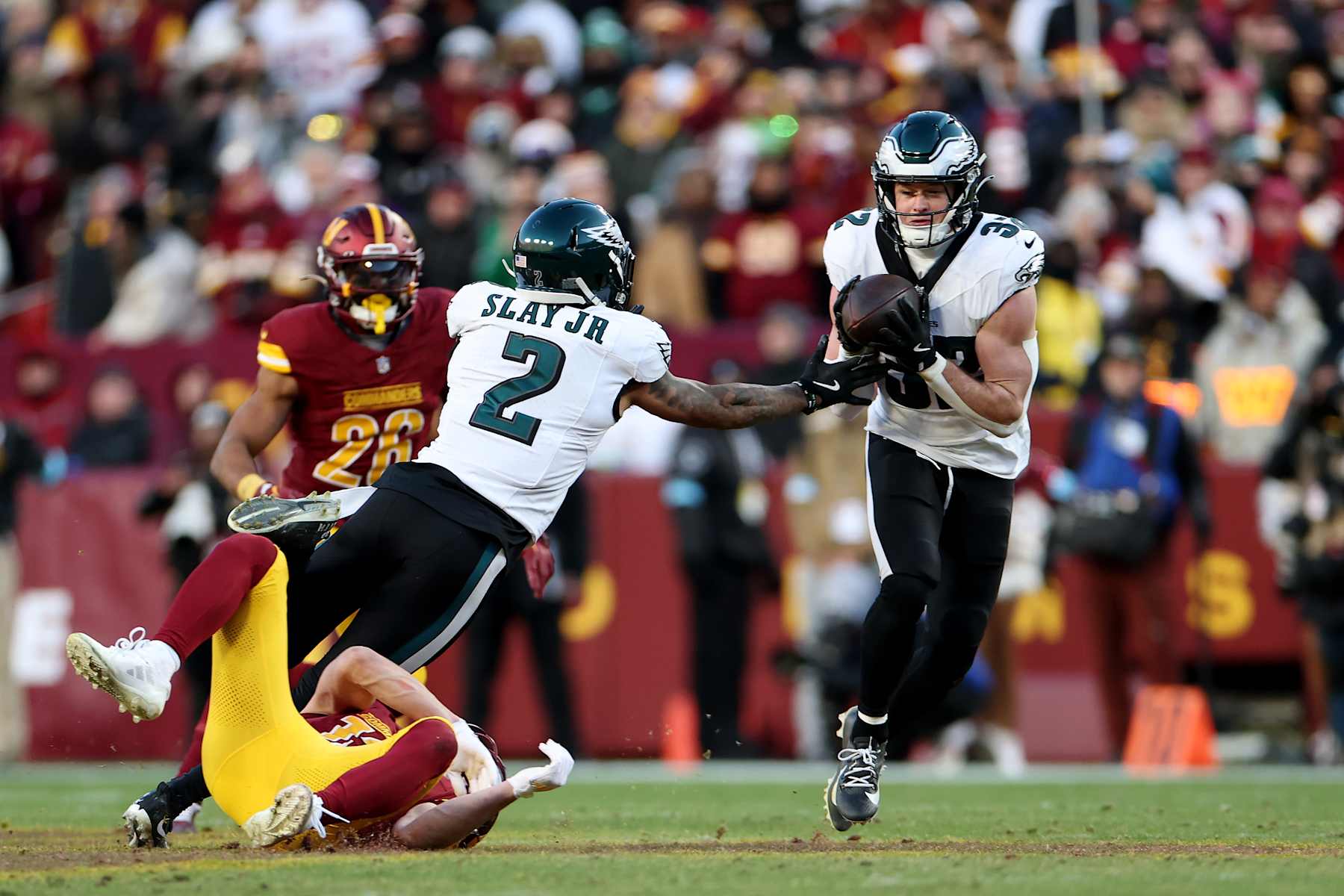 LANDOVER, MARYLAND - DECEMBER 22: Reed Blankenship #32 of the Philadelphia Eagles intercepts a pass intended for Luke McCaffrey #12 of the Washington Commanders during the fourth quarter at Northwest Stadium on December 22, 2024 in Landover, Maryland. (Photo by Scott Taetsch/Getty Images)