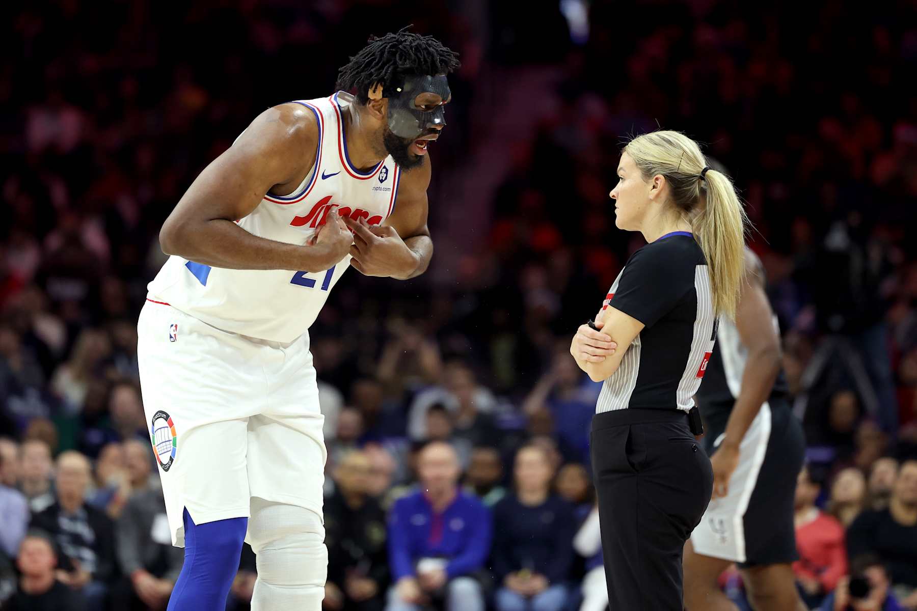 PHILADELPHIA, PENNSYLVANIA - DECEMBER 23: Joel Embiid #21 of the Philadelphia 76ers argues a call with referee Jenna Schroeder #20 during the first half against the San Antonio Spurs at the Wells Fargo Center on December 23, 2024 in Philadelphia, Pennsylvania. Embiid was ejected from the game with two technical fouls. NOTE TO USER: User expressly acknowledges and agrees that, by downloading and or using this photograph, User is consenting to the terms and conditions of the Getty Images License Agreement. (Photo by Emilee Chinn/Getty Images)