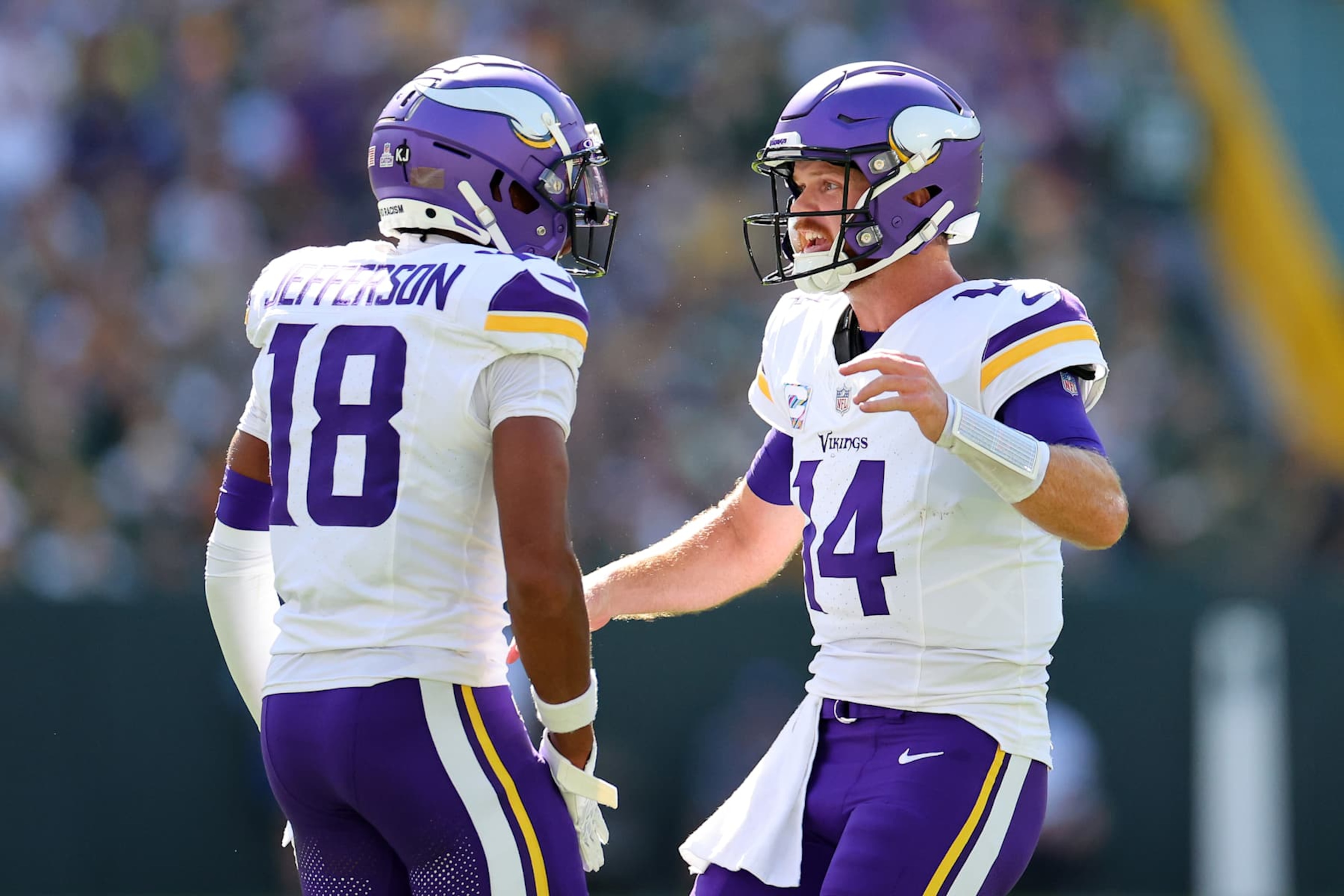 GREEN BAY, WISCONSIN - SEPTEMBER 29: Justin Jefferson #18 and Sam Darnold #14 of the Minnesota Vikings celebrate a touchdown against the Green Bay Packers during the first quarter of the game at Lambeau Field on September 29, 2024 in Green Bay, Wisconsin. (Photo by Stacy Revere/Getty Images) GREEN BAY, WISCONSIN - SEPTEMBER 29: Justin Jefferson #18 and Sam Darnold #14 of the Minnesota Vikings celebrate a touchdown against the Green Bay Packers during the first quarter of the game at Lambeau Field on September 29, 2024 in Green Bay, Wisconsin. (Photo by Stacy Revere/Getty Images)