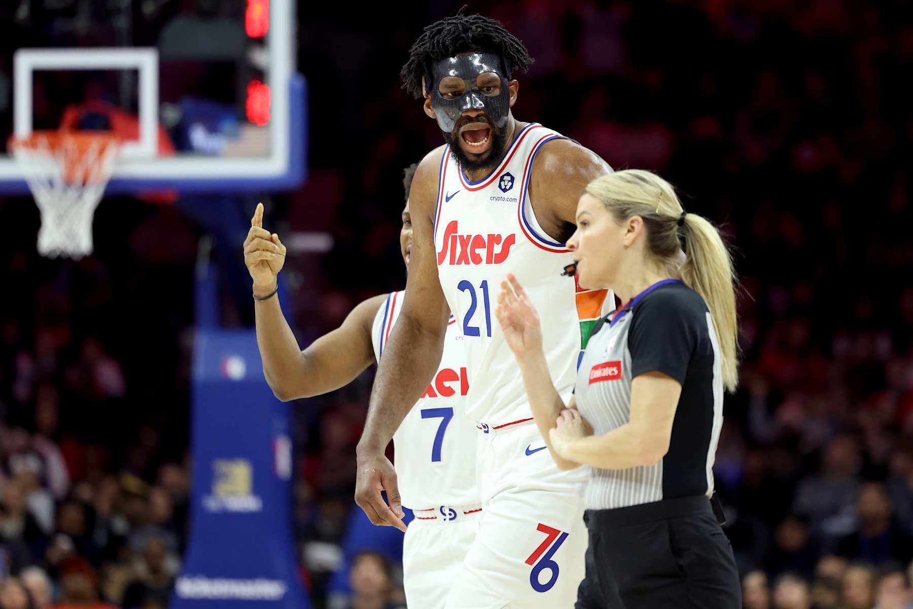 PHILADELPHIA, PENNSYLVANIA - DECEMBER 23: Joel Embiid #21 of the Philadelphia 76ers argues a call with referee Jenna Schroeder #20 during the first half against the San Antonio Spurs at the Wells Fargo Center on December 23, 2024 in Philadelphia, Pennsylvania. Embiid was ejected from the game with two technical fouls. NOTE TO USER: User expressly acknowledges and agrees that, by downloading and or using this photograph, User is consenting to the terms and conditions of the Getty Images License Agreement. (Photo by Emilee Chinn/Getty Images)