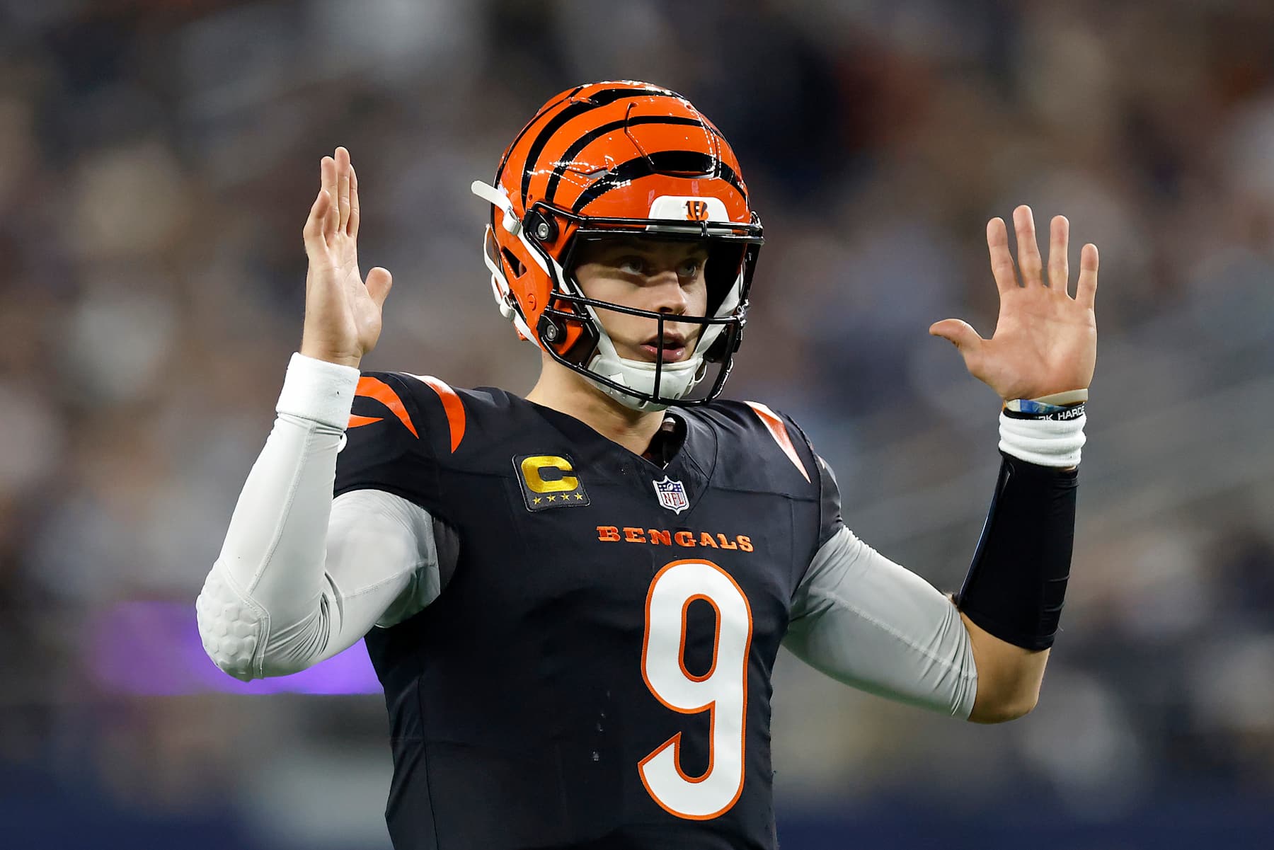ARLINGTON, TEXAS - DECEMBER 09: Joe Burrow #9 of the Cincinnati Bengals celebrates a touchdown scored by Chase Brown #30 against the Dallas Cowboys during the second quarter in the game at AT&T Stadium on December 09, 2024 in Arlington, Texas. (Photo by Ron Jenkins/Getty Images)