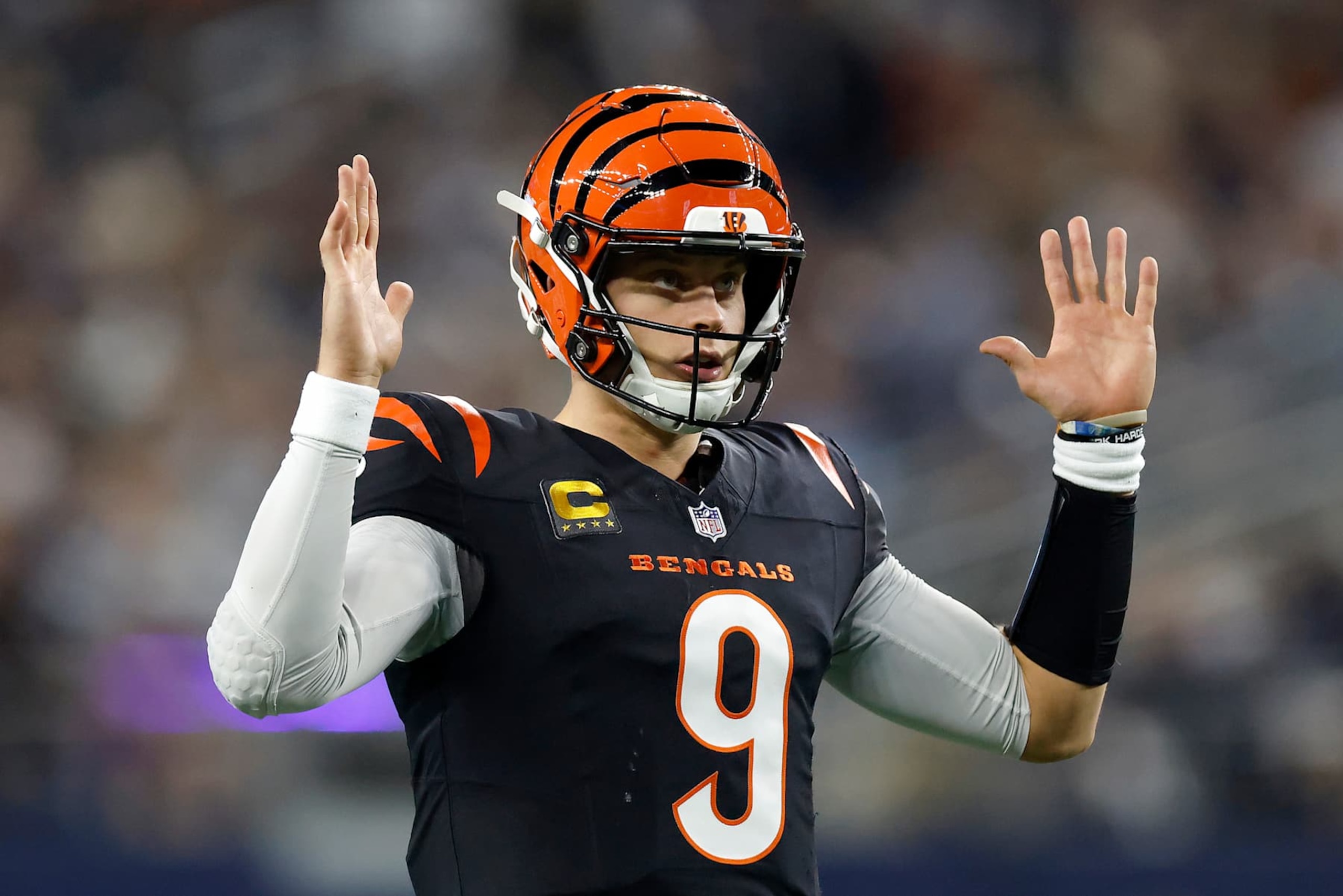 ARLINGTON, TEXAS - DECEMBER 09: Joe Burrow #9 of the Cincinnati Bengals celebrates a touchdown scored by Chase Brown #30 against the Dallas Cowboys during the second quarter in the game at AT&T Stadium on December 09, 2024 in Arlington, Texas. (Photo by Ron Jenkins/Getty Images)