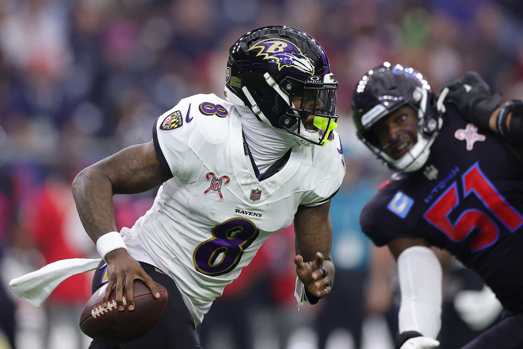 HOUSTON, TEXAS - DECEMBER 25: Lamar Jackson #8 of the Baltimore Ravens runs the ball during the first quarter against the Houston Texans at NRG Stadium on December 25, 2024 in Houston, Texas. (Photo by Alex Slitz/Getty Images)