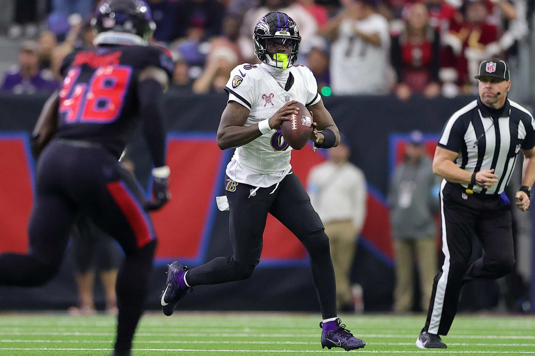 HOUSTON, TEXAS - DECEMBER 25: Lamar Jackson #8 of the Baltimore Ravens scrambles during the second quarter against the Houston Texans at NRG Stadium on December 25, 2024 in Houston, Texas. (Photo by Alex Slitz/Getty Images)