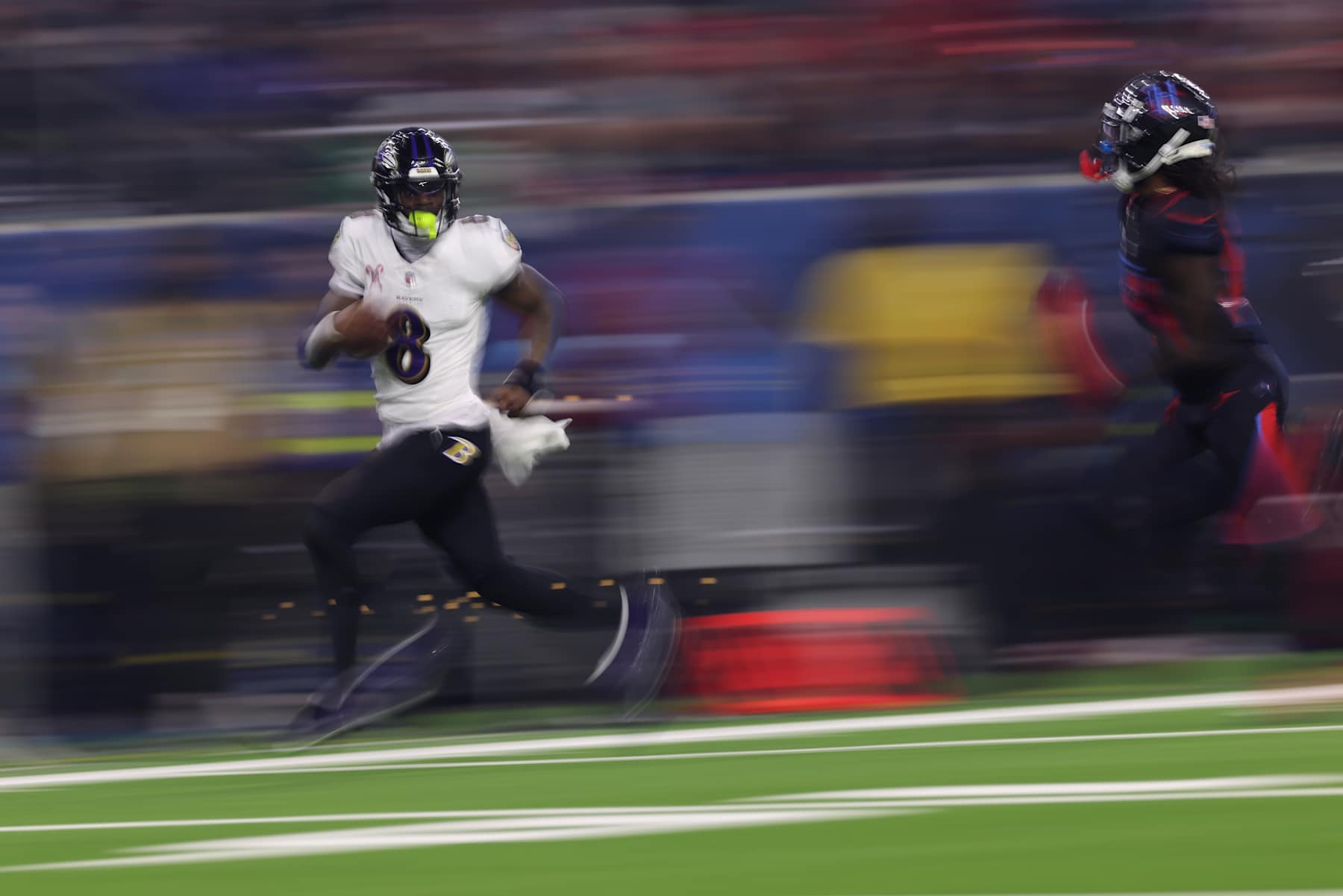 HOUSTON, TEXAS - DECEMBER 25: Lamar Jackson #8 of the Baltimore Ravens runs the ball for a touchdown during the third quarter against the Houston Texans at NRG Stadium on December 25, 2024 in Houston, Texas. (Photo by Tim Warner/Getty Images)