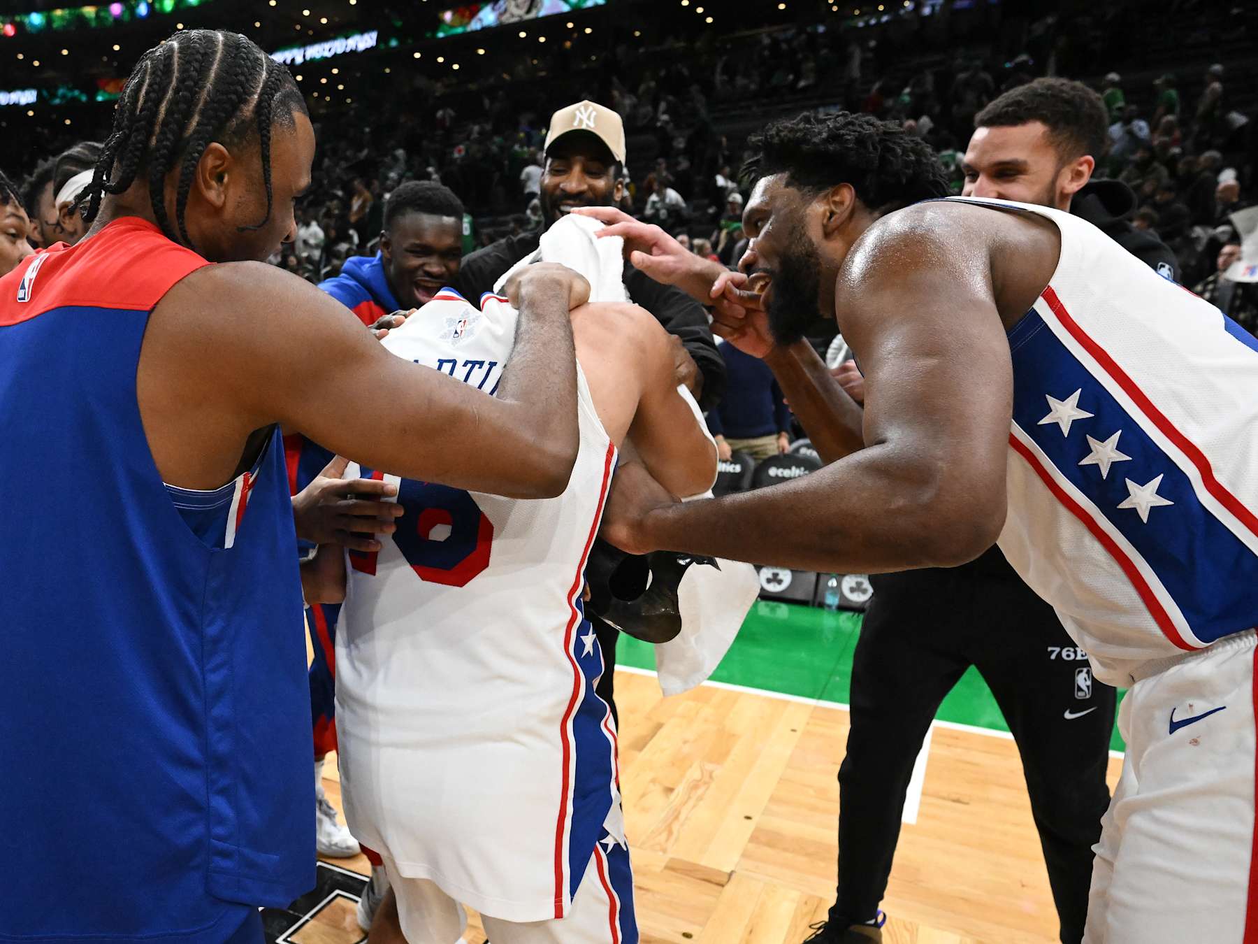 BOSTON, MASSACHUSETTS - DECEMBER 25: Joel Embiid #21 of  reacts with Caleb Martin #16 of the Philadelphia 76ers after a game against the Boston Celtics during the fourth quarter at the the TD Garden on December 25, 2024 in Boston, Massachusetts. NOTE TO USER: User expressly acknowledges and agrees that, by downloading and or using this photograph, User is consenting to the terms and conditions of the Getty Images License Agreement. (Photo by Brian Fluharty/Getty Images)