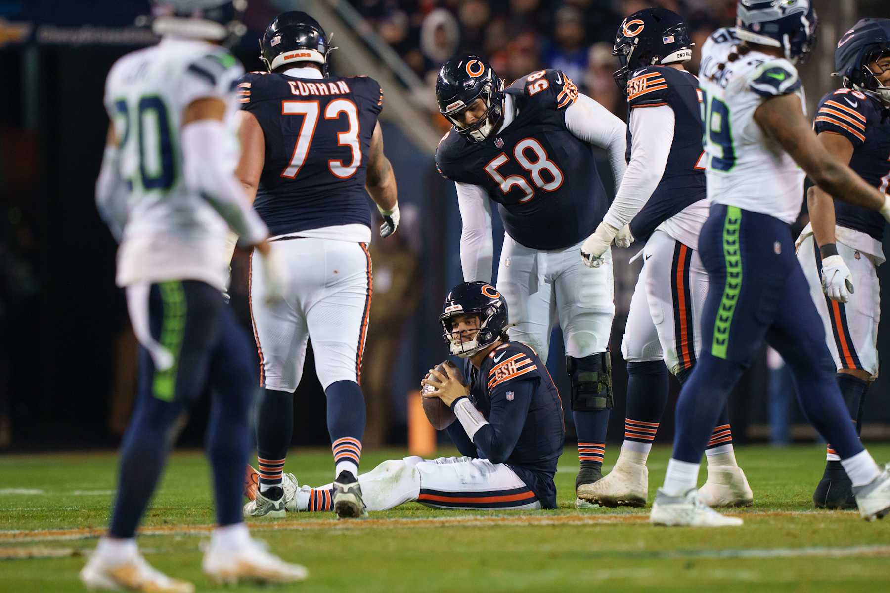 CHICAGO, ILLINOIS  - DECEMBER 26: Quarterback Caleb Williams #18 of the Chicago Bears sits on the ground following a play during the fourth quarter of an NFL football game against the Seattle Seahawks at Soldier Field on December 26, 2024 in Chicago, Illinois. (Photo by Todd Rosenberg/Getty Images)