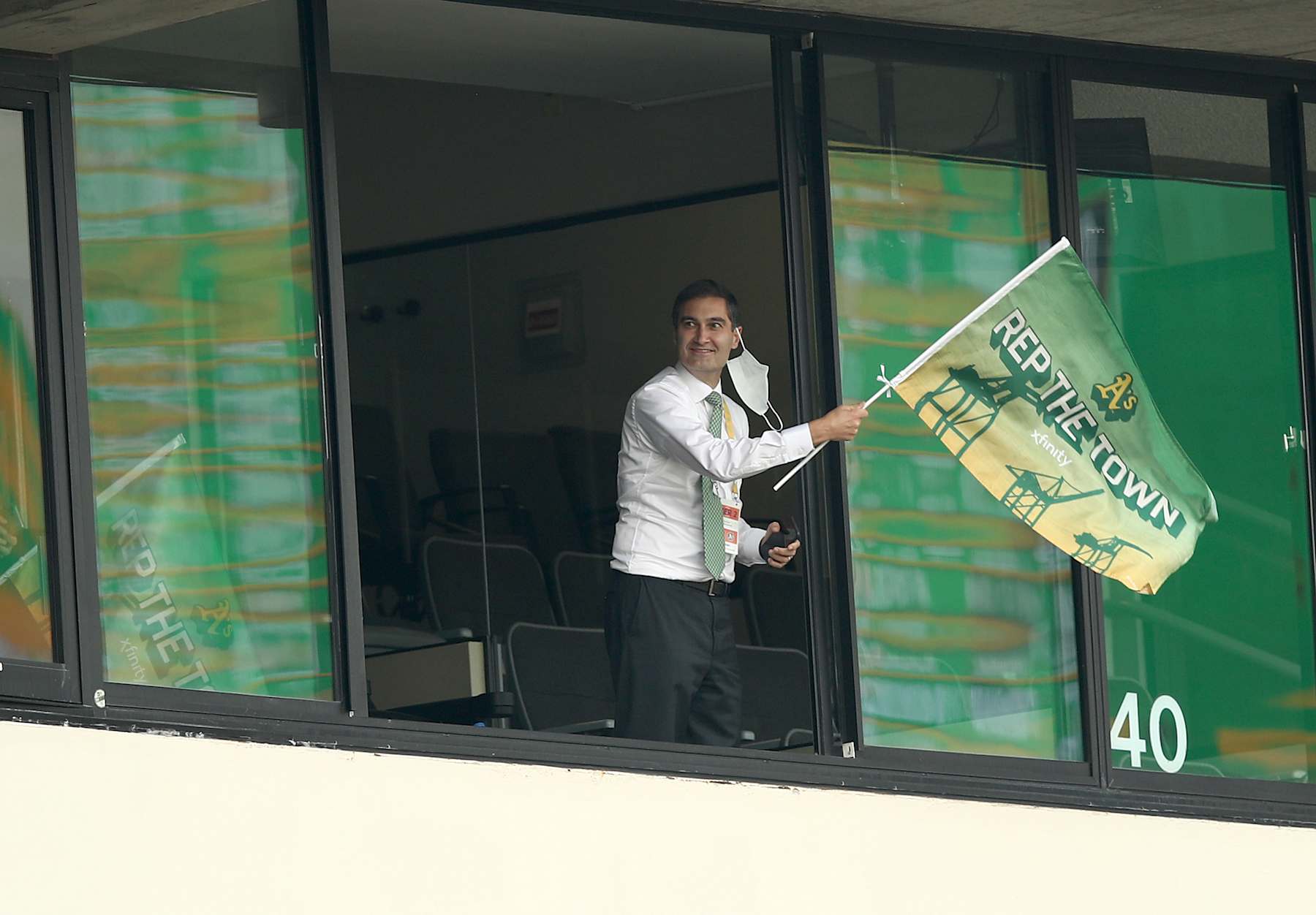 OAKLAND, CALIFORNIA - OCTOBER 01:  Oakland Athletics team president Dave Kaval waves a flag after they tied their game against the Chicago White Sox in the fourth inning of Game Three of the American League wild card series  at RingCentral Coliseum on October 01, 2020 in Oakland, California. (Photo by Ezra Shaw/Getty Images)