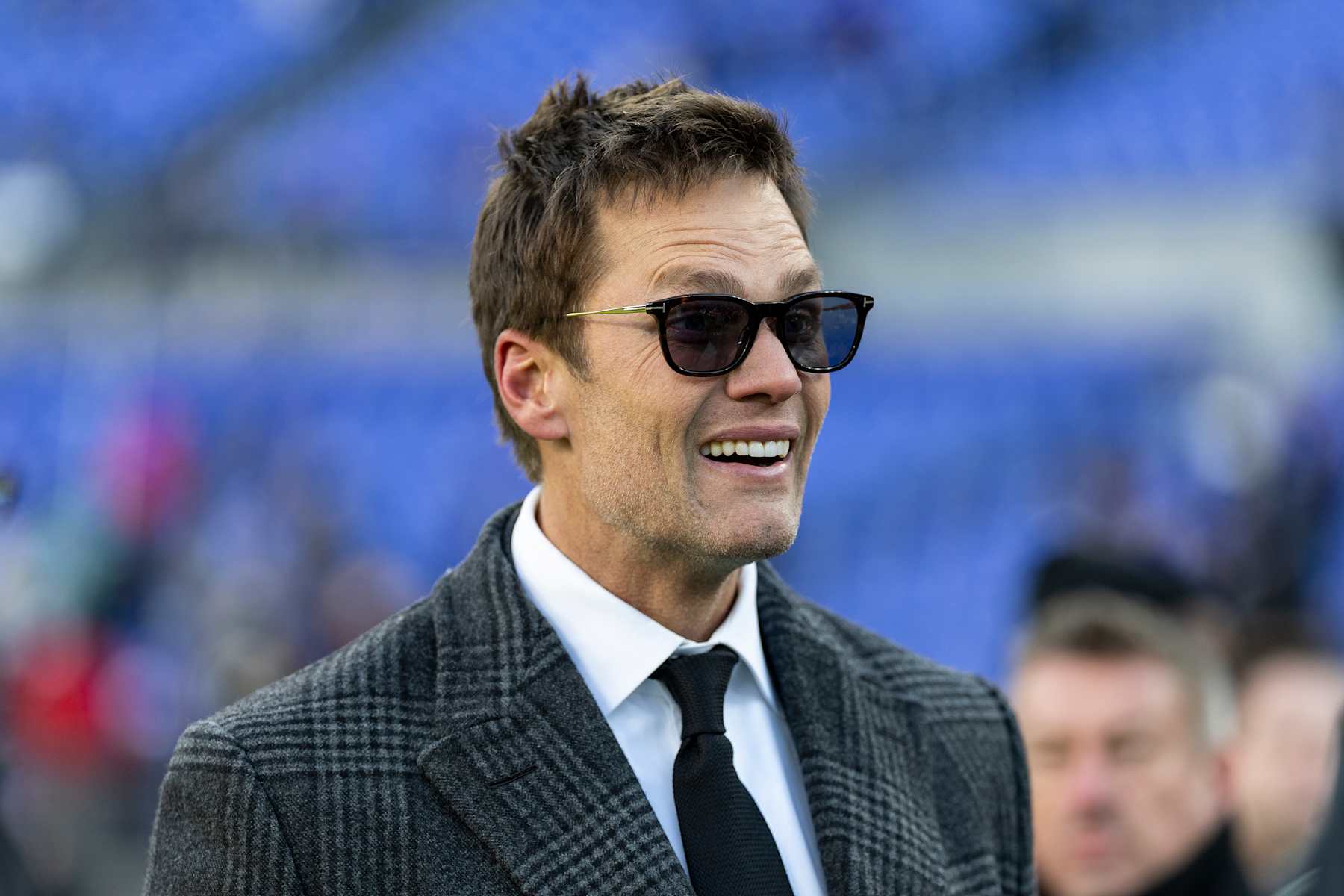 BALTIMORE, MARYLAND - DECEMBER 21: Former NFL quarterback Tom Brady reacts prior to an NFL Football game at M&T Bank Stadium on December 21, 2024 in Baltimore, Maryland. (Photo by Michael Owens/Getty Images)