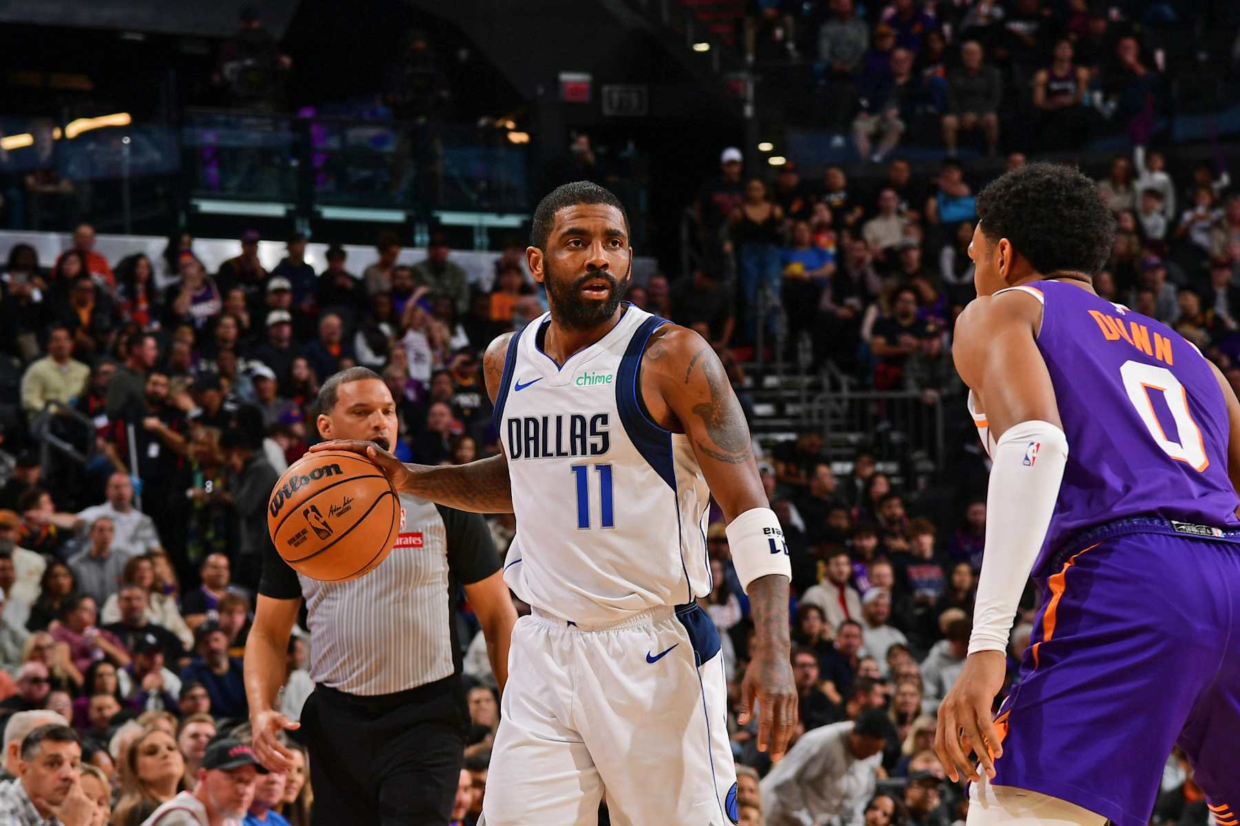PHOENIX, AZ - DECEMBER 27: Kyrie Irving #11 of the Dallas Mavericks handles the ball during the game against the Phoenix Suns on December 27, 2024 at Footprint Center in Phoenix, Arizona. NOTE TO USER: User expressly acknowledges and agrees that, by downloading and or using this photograph, user is consenting to the terms and conditions of the Getty Images License Agreement. Mandatory Copyright Notice: Copyright 2024 NBAE (Photo by Kate Frese/NBAE via Getty Images)