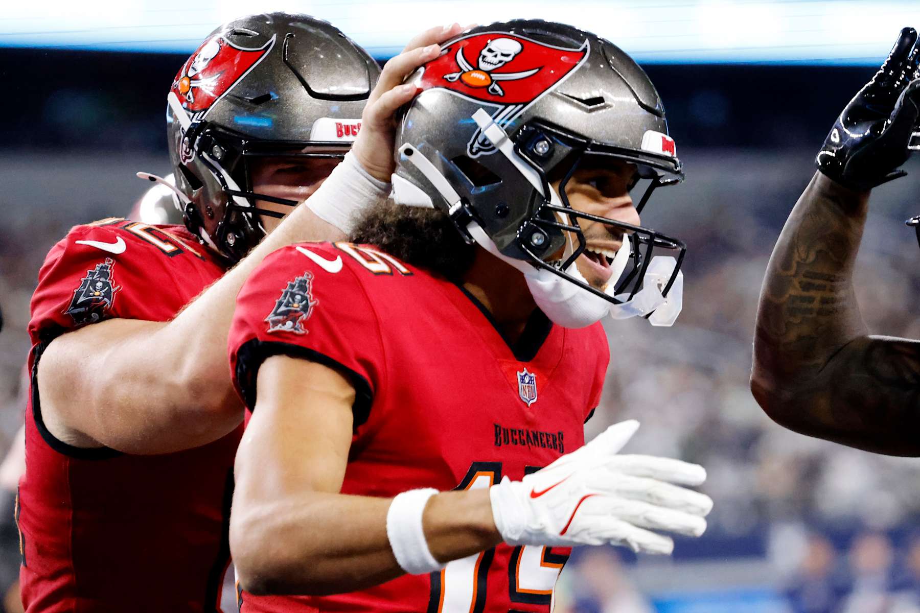 ARLINGTON, TEXAS - DECEMBER 22: Jalen McMillan #15 of the Tampa Bay Buccaneers celebrates with teammates after a second quarter touchdown against the Dallas Cowboys at AT&T Stadium on December 22, 2024 in Arlington, Texas. (Photo by Ron Jenkins/Getty Images)