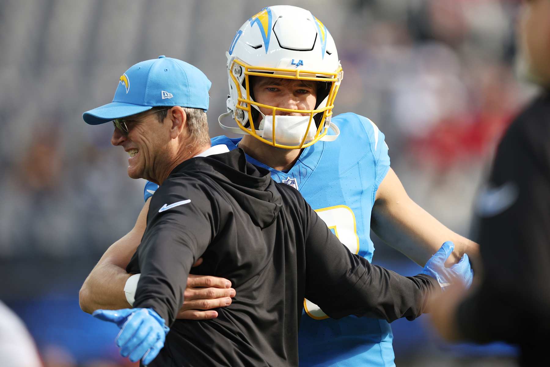 INGLEWOOD, CALIFORNIA - DECEMBER 15: Head coach Jim Harbaugh and Justin Herbert #10 of the Los Angeles Chargers  embrace on field prior to game against the Tampa Bay Buccaneers at SoFi Stadium on December 15, 2024 in Inglewood, California. (Photo by Harry How/Getty Images)