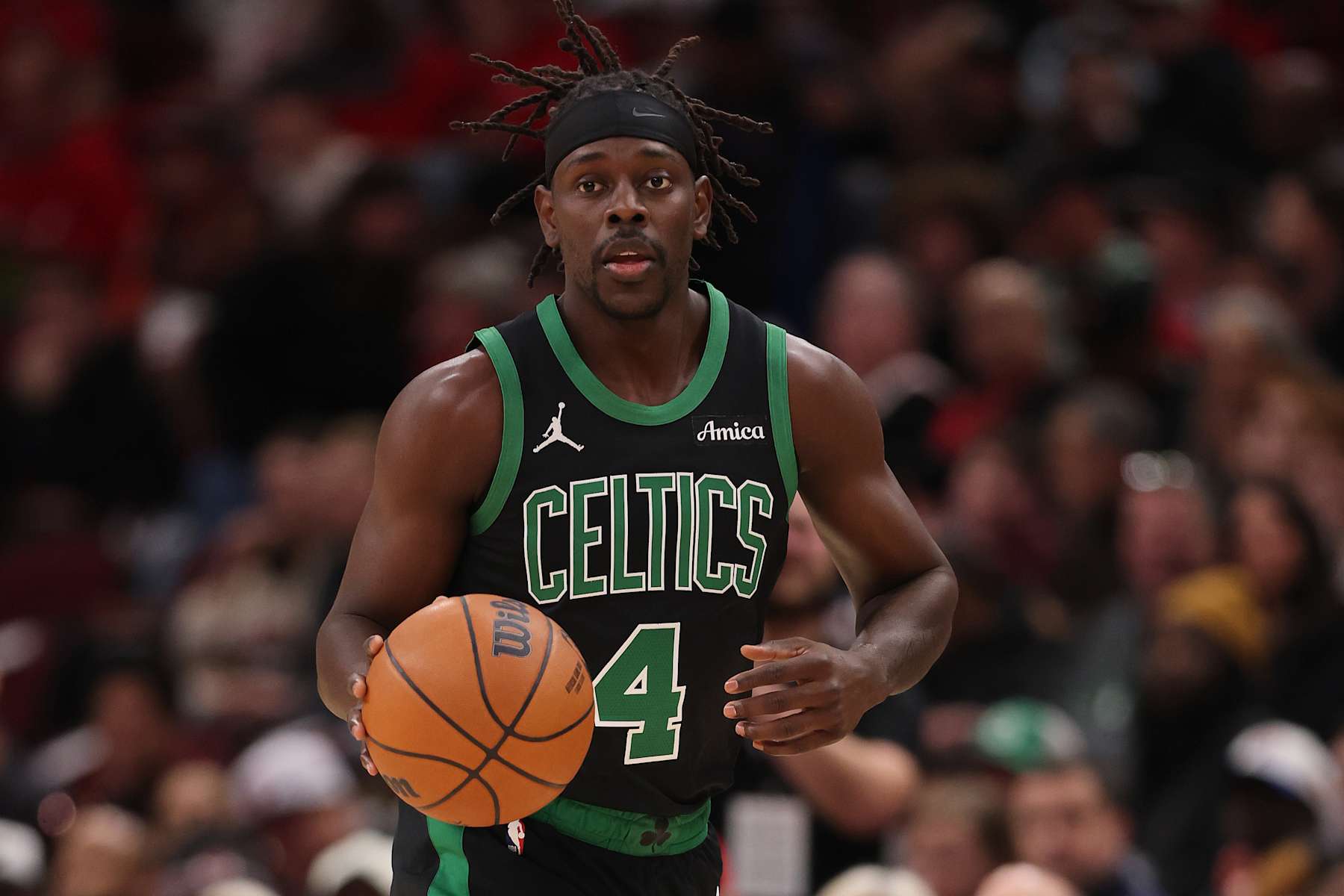 CHICAGO, ILLINOIS - DECEMBER 21: Jrue Holiday #4 of the Boston Celtics dribbles up the court against the Chicago Bulls during the first half at the United Center on December 21, 2024 in Chicago, Illinois. NOTE TO USER: User expressly acknowledges and agrees that, by downloading and or using this photograph, User is consenting to the terms and conditions of the Getty Images License Agreement. (Photo by Michael Reaves/Getty Images)