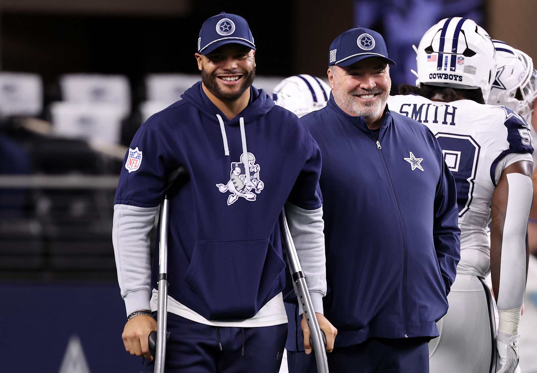 ARLINGTON, TEXAS - DECEMBER 09: Dak Prescott #4 of the Dallas Cowboys stands on the sideline with crutches as he smiles with head coach Mike McCarthy prior to the game against the Cincinnati Bengals at AT&T Stadium on December 09, 2024 in Arlington, Texas. (Photo by Sam Hodde/Getty Images)