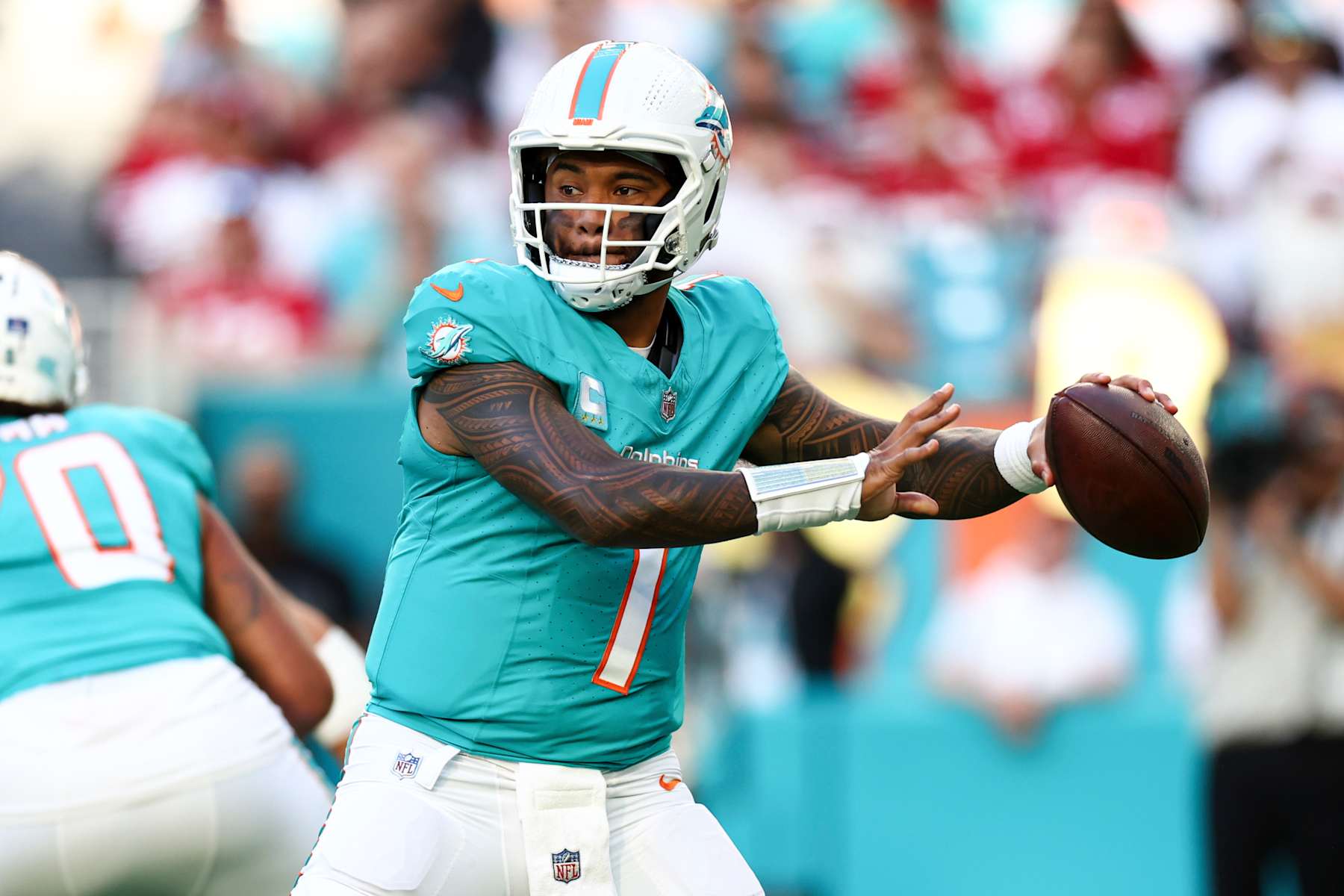 MIAMI GARDENS, FLORIDA - DECEMBER 22: Tua Tagovailoa #1 of the Miami Dolphins looks to throw a pass during the first half of an NFL football game against the San Francisco 49ers at Hard Rock Stadium on December 22, 2024 in Miami Gardens, Florida. (Photo by Kevin Sabitus/Getty Images)