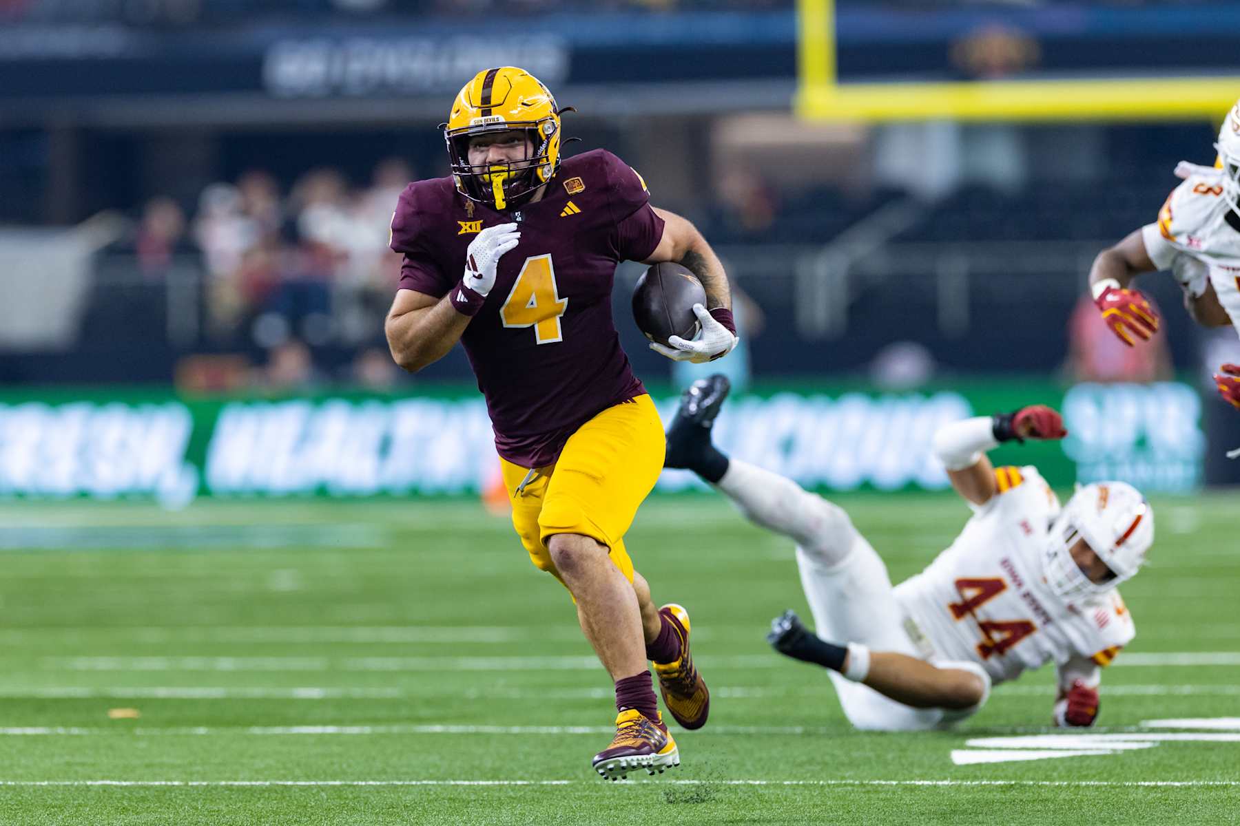 ARLINGTON, TX - DECEMBER 07: Arizona State Sun Devils running back Cam Skattebo (#4) runs up field during the Big 12 championship football game between the Arizona State Sun Devils and the Iowa State Cyclones on December 7, 2024 at AT&T Stadium in Arlington, TX.  (Photo by Matthew Visinsky/Icon Sportswire via Getty Images)