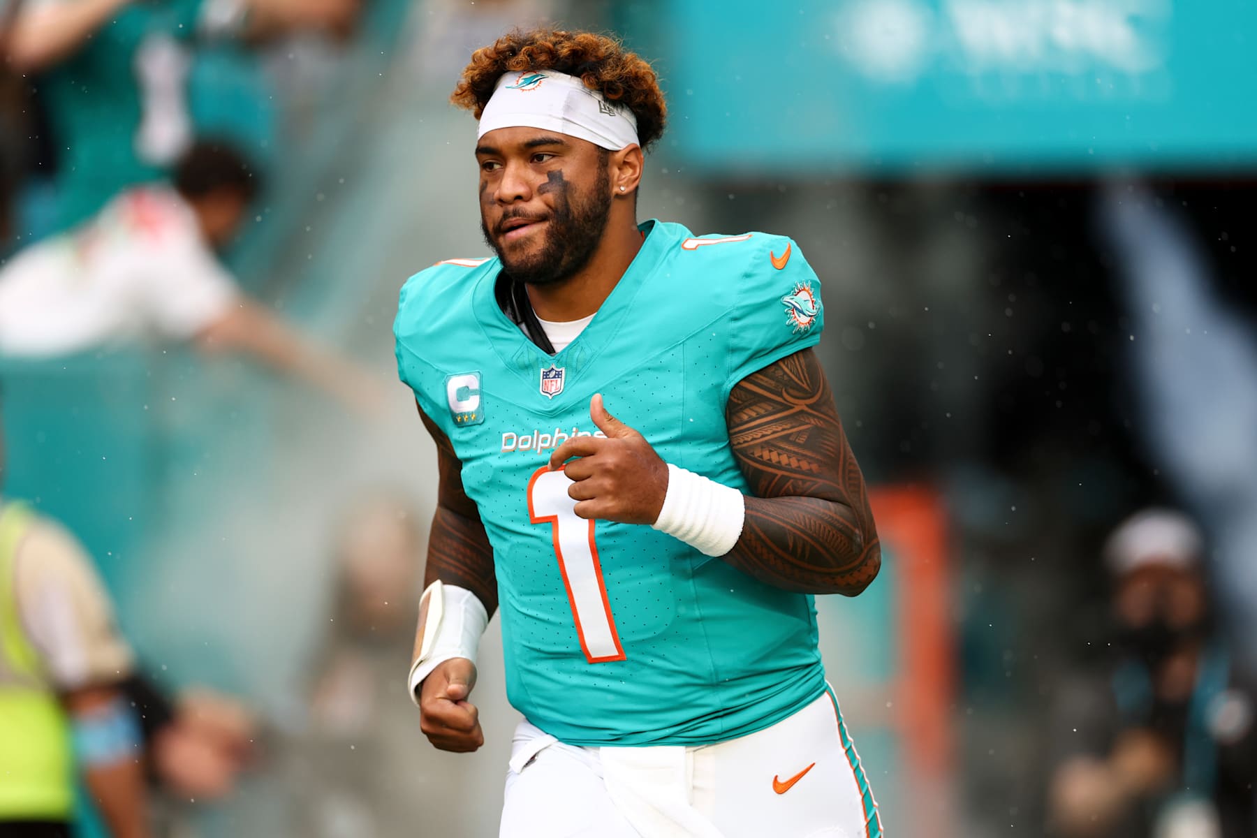 MIAMI GARDENS, FLORIDA - DECEMBER 22: Tua Tagovailoa #1 of the Miami Dolphins runs onto the field before an NFL football game against the San Francisco 49ers at Hard Rock Stadium on December 22, 2024 in Miami Gardens, Florida. (Photo by Kevin Sabitus/Getty Images)