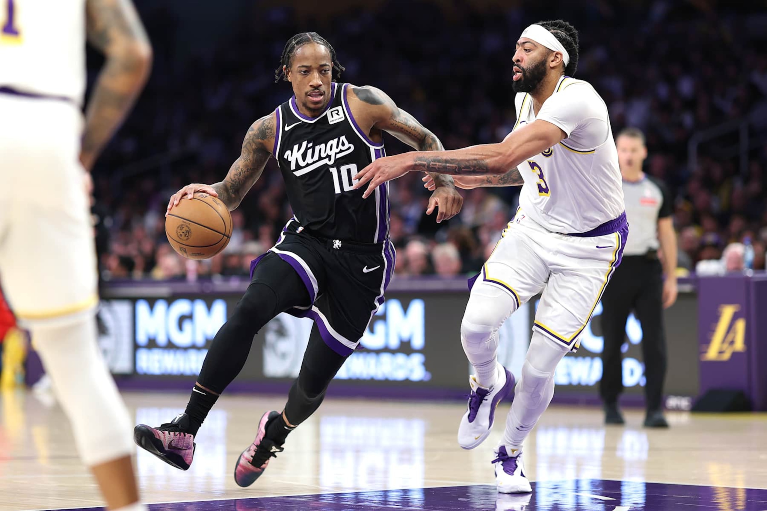LOS ANGELES, CALIFORNIA - DECEMBER 28: DeMar DeRozan #10 of the Sacramento Kings dribbles past the defense of Anthony Davis #3 of the Los Angeles Lakers during the first half of a game at Crypto.com Arena on December 28, 2024 in Los Angeles, California. (Photo by Sean M. Haffey/Getty Images)