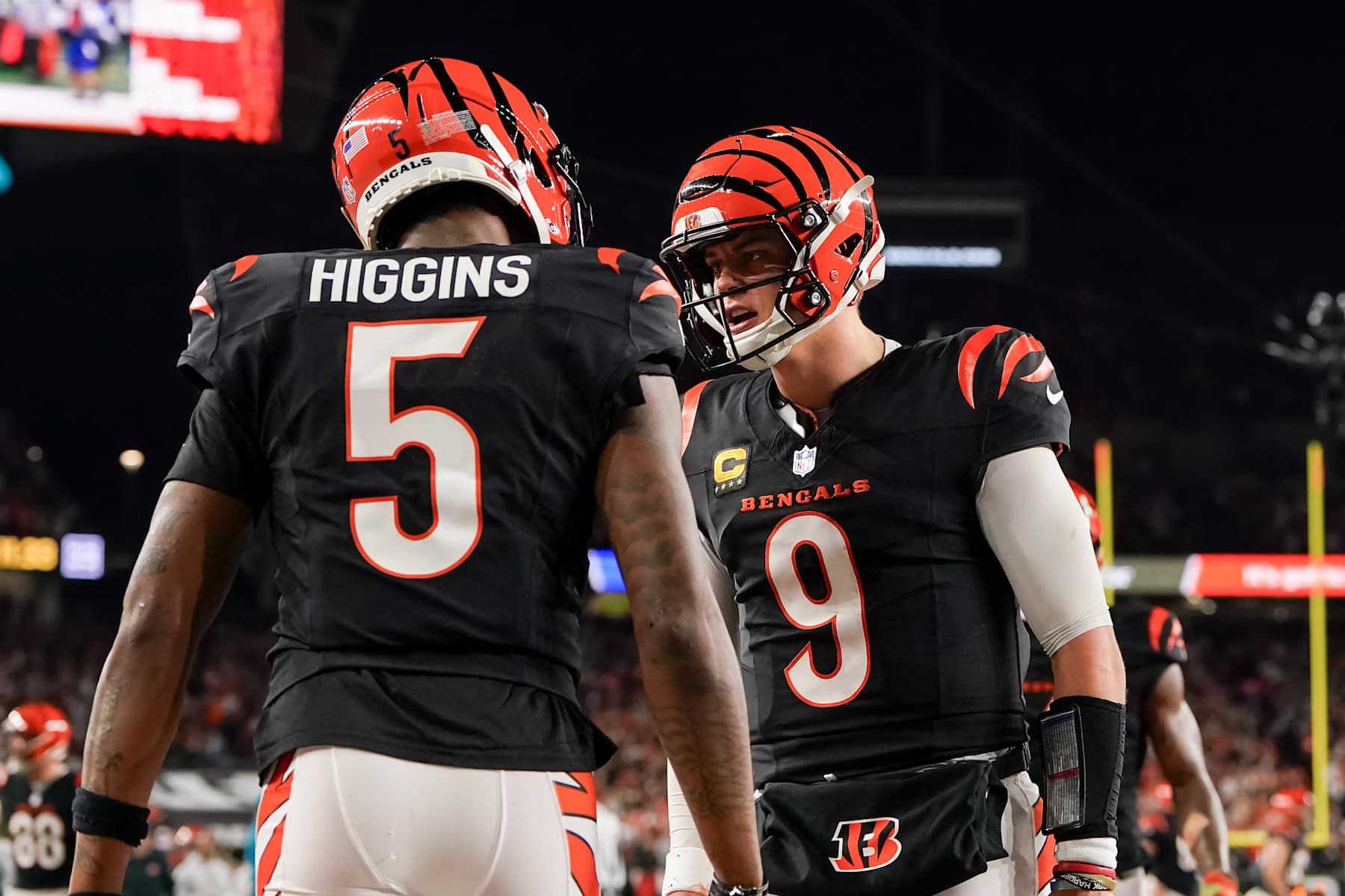 CINCINNATI, OHIO - DECEMBER 28: Tee Higgins #5 and Joe Burrow #9 of the Cincinnati Bengals celebrate after scoring a touchdown in the fourth quarter against the Denver Broncos at Paycor Stadium on December 28, 2024 in Cincinnati, Ohio. (Photo by Dylan Buell/Getty Images)