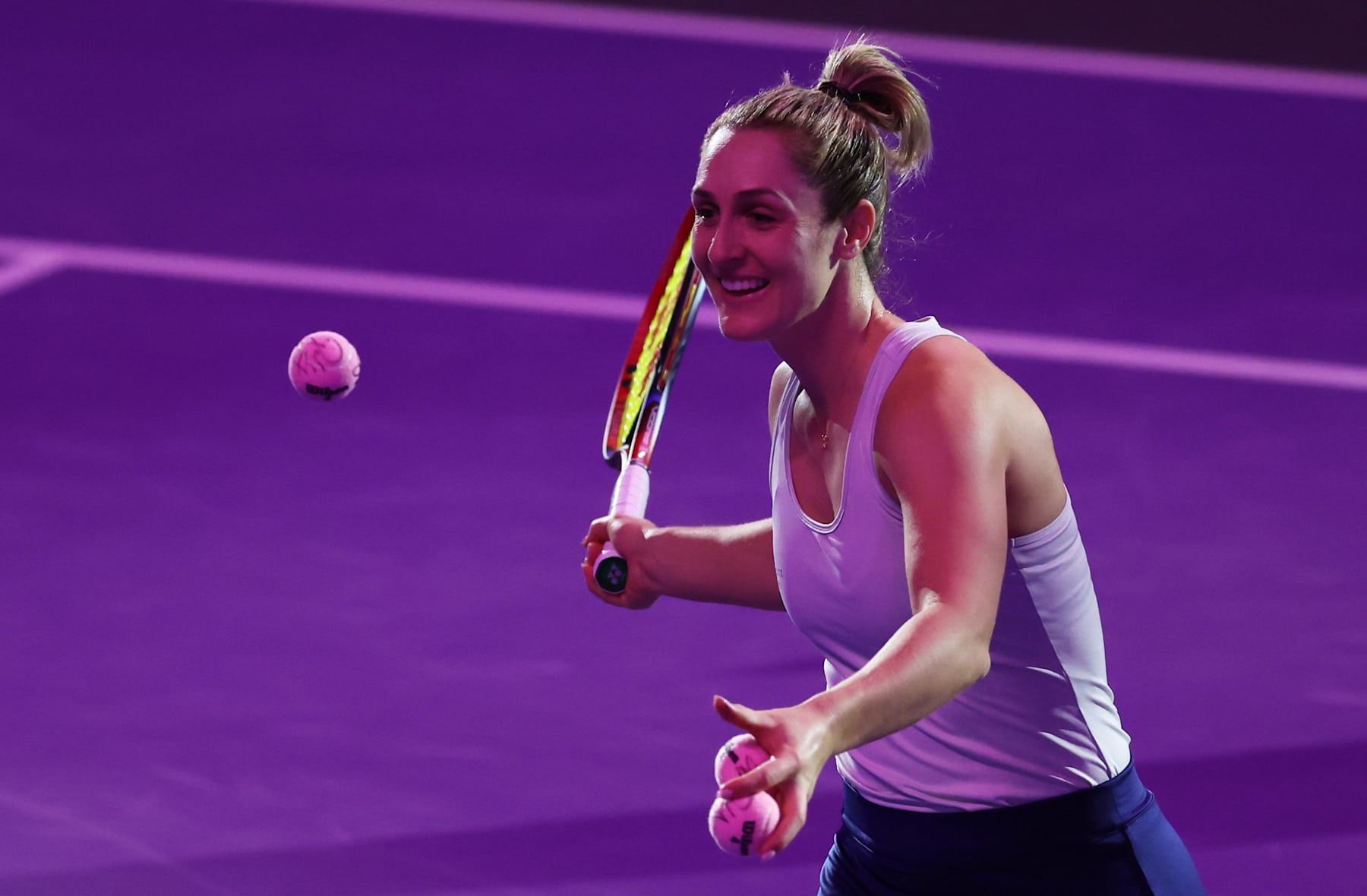 RIYADH, SAUDI ARABIA - NOVEMBER 07: Gabriela Dabrowski of Canada hits pink signed tennis balls for breast cancer awareness into the crowd with Erin Routliffe of New Zealand i(out of pic) after their victory against Caroline Dolehide of the United States and Desirae Krawczyk of the United States in their round robin doubles match during Day 6 of the 2024 WTA Finals Riyadh as part of the Hologic WTA Tour at King Saud University Indoor Arena on November 07, 2024 in Riyadh, Saudi Arabia. (Photo by Clive Brunskill/Getty Images)