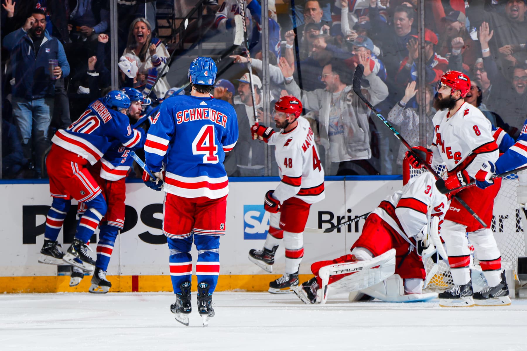NEW YORK, NEW YORK - MAY 07: Alexis Lafreniere #13 of the New York Rangers celebrates his goal with Artemi Panarin #10 and Braden Schneider #4 during the second period against the Carolina Hurricanes in Game Two of the Second Round of the 2024 Stanley Cup Playoffs at Madison Square Garden on May 7, 2024 in New York City. (Photo by Jared Silber/NHLI via Getty Images)