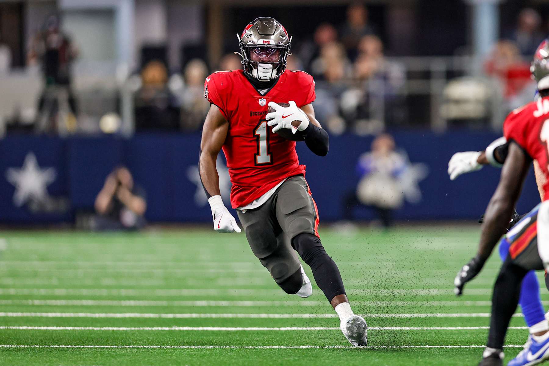 ARLINGTON, TX - DECEMBER 22: Tampa Bay Buccaneers running back Rachaad White (1) runs for a first down during the game between the Dallas Cowboys and the Tampa Bay Buccaneers on December 22, 2024 at AT&T Stadium in Arlington, Texas. (Photo by Matthew Pearce/Icon Sportswire via Getty Images)