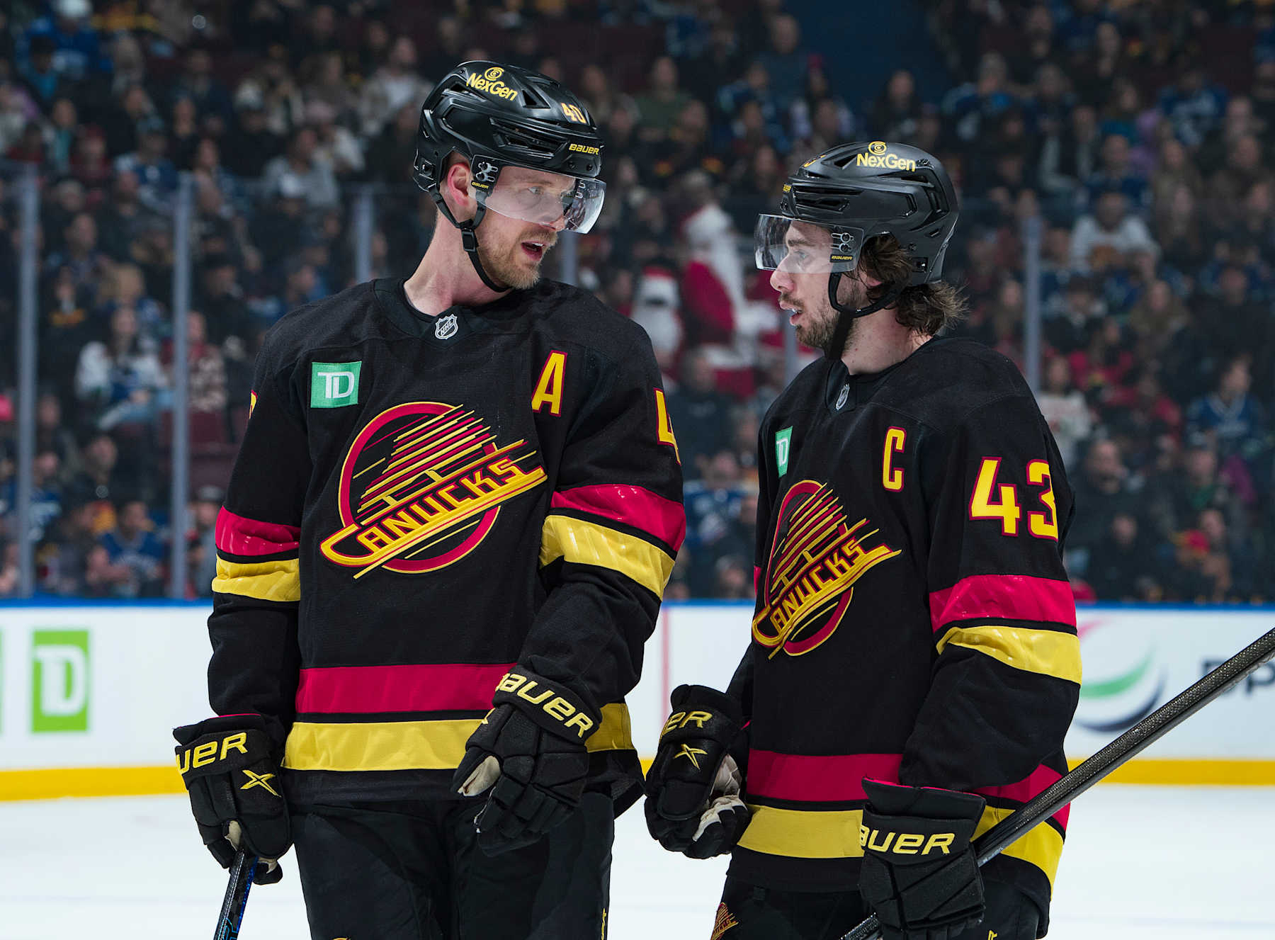 VANCOUVER, CANADA - DECEMBER 21: Elias Pettersson #40 of the Vancouver Canucks talks to Quinn Hughes #43 during their NHL game against the Ottawa Senators at Rogers Arena on December 21, 2024 in Vancouver, British Columbia, Canada. (Photo by Jeff Vinnick/NHLI via Getty Images)