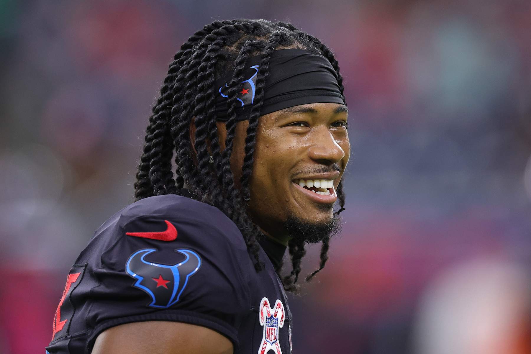 HOUSTON, TEXAS - DECEMBER 25: John Metchie III #8 of the Houston Texans warms up prior to the game against the Baltimore Ravens at NRG Stadium on December 25, 2024 in Houston, Texas. (Photo by Alex Slitz/Getty Images)