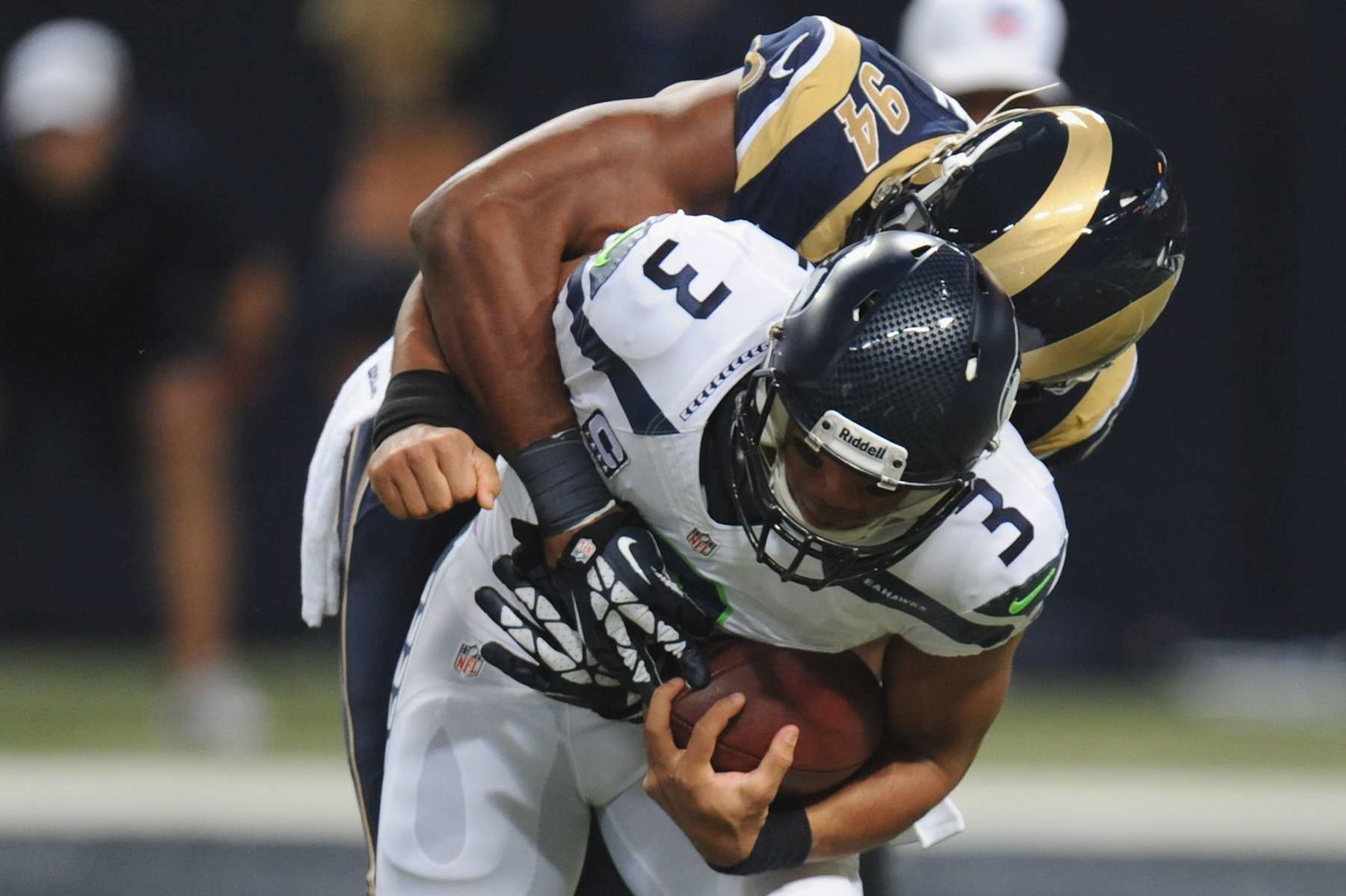 ST. LOUIS, MO - OCTOBER 28: Russell Wilson #3 of the Seattle Seahawks is sacked during the first quarter by Robert Quinn #94 of the St. Louis Rams at the Edward Jones Dome on October 28, 2013 in St. Louis, Missouri. (Photo by Michael Thomas/Getty Images)