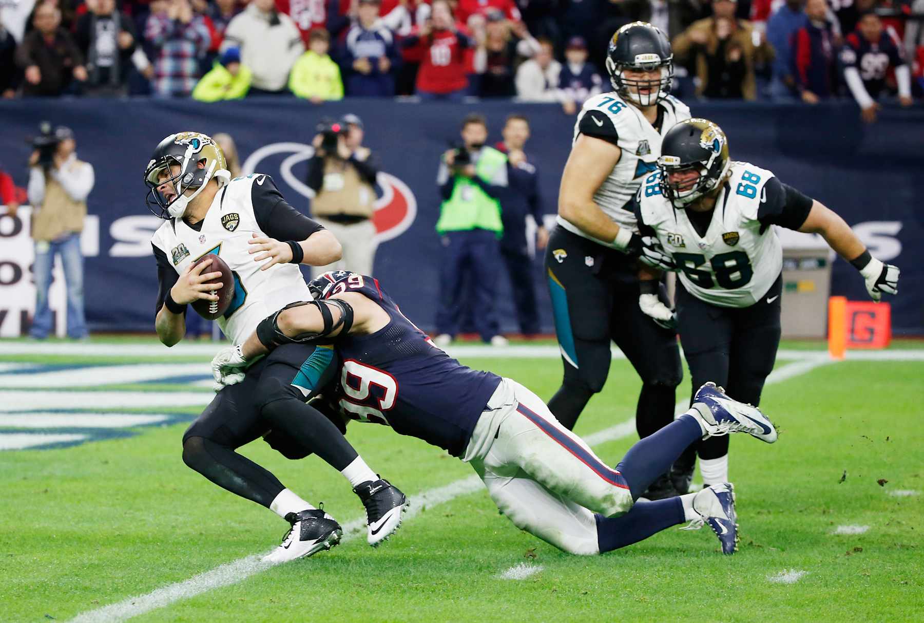 HOUSTON, TX - DECEMBER 28: Blake Bortles #5 of the Jacksonville Jaguars is sacked by J.J. Watt #99 of the Houston Texans in the fourth quarter during their game at NRG Stadium on December 28, 2014 in Houston, Texas. (Photo by Scott Halleran/Getty Images)