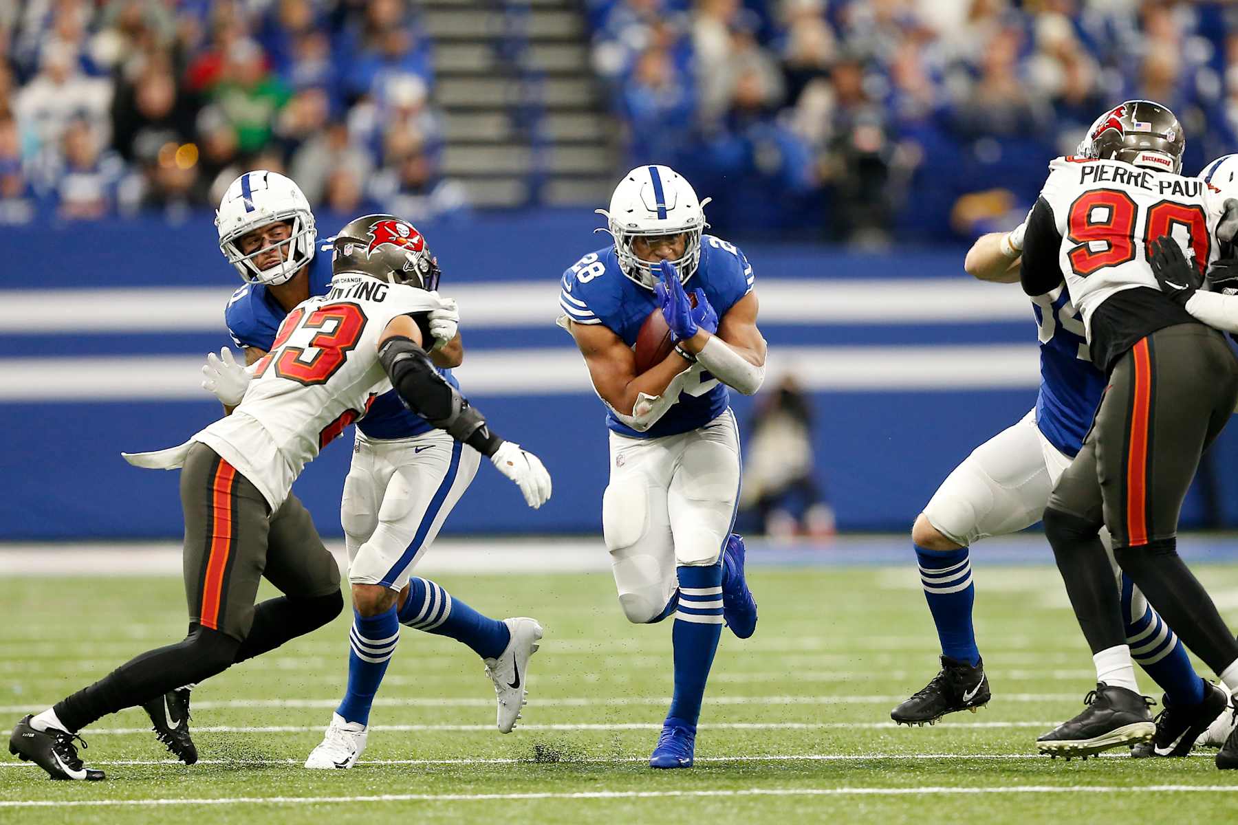 INDIANAPOLIS, IN - NOVEMBER 28: Indianapolis Colts Running Back Jonathan Taylor (28) runs through the hole during a NFL game between the Tampa Bay Buccaneers and the Indianapolis Colts on November 28, 2021, at Lucas Oil Stadium in Indianapolis, IN. (Photo by Jeffrey Brown/Icon Sportswire via Getty Images)
