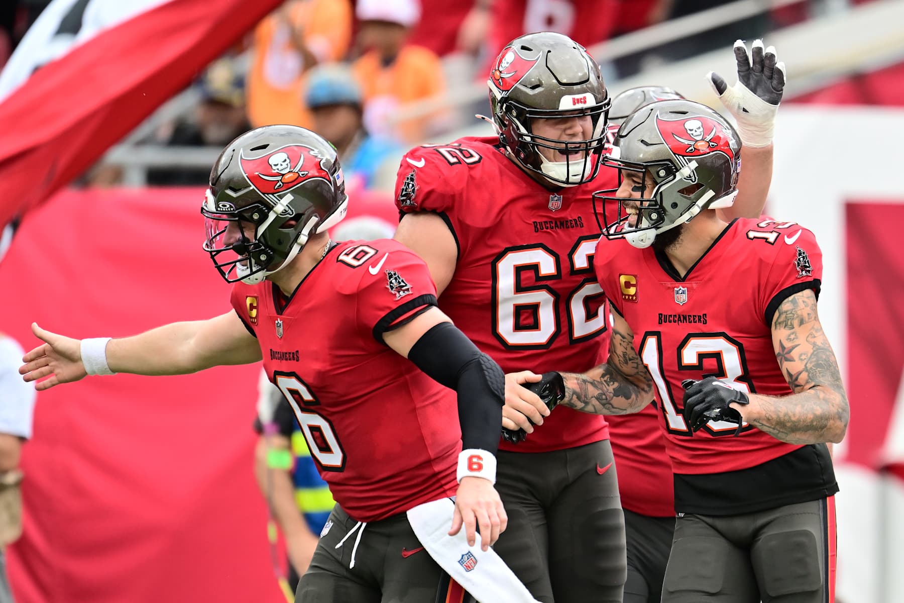 TAMPA, FLORIDA - DECEMBER 29: Mike Evans #13 of the Tampa Bay Buccaneers celebrates with Graham Barton #62 and Baker Mayfield #6 of the Tampa Bay Buccaneers after a touchdown in the second quarter against the Carolina Panthers at Raymond James Stadium on December 29, 2024 in Tampa, Florida. (Photo by Julio Aguilar/Getty Images)