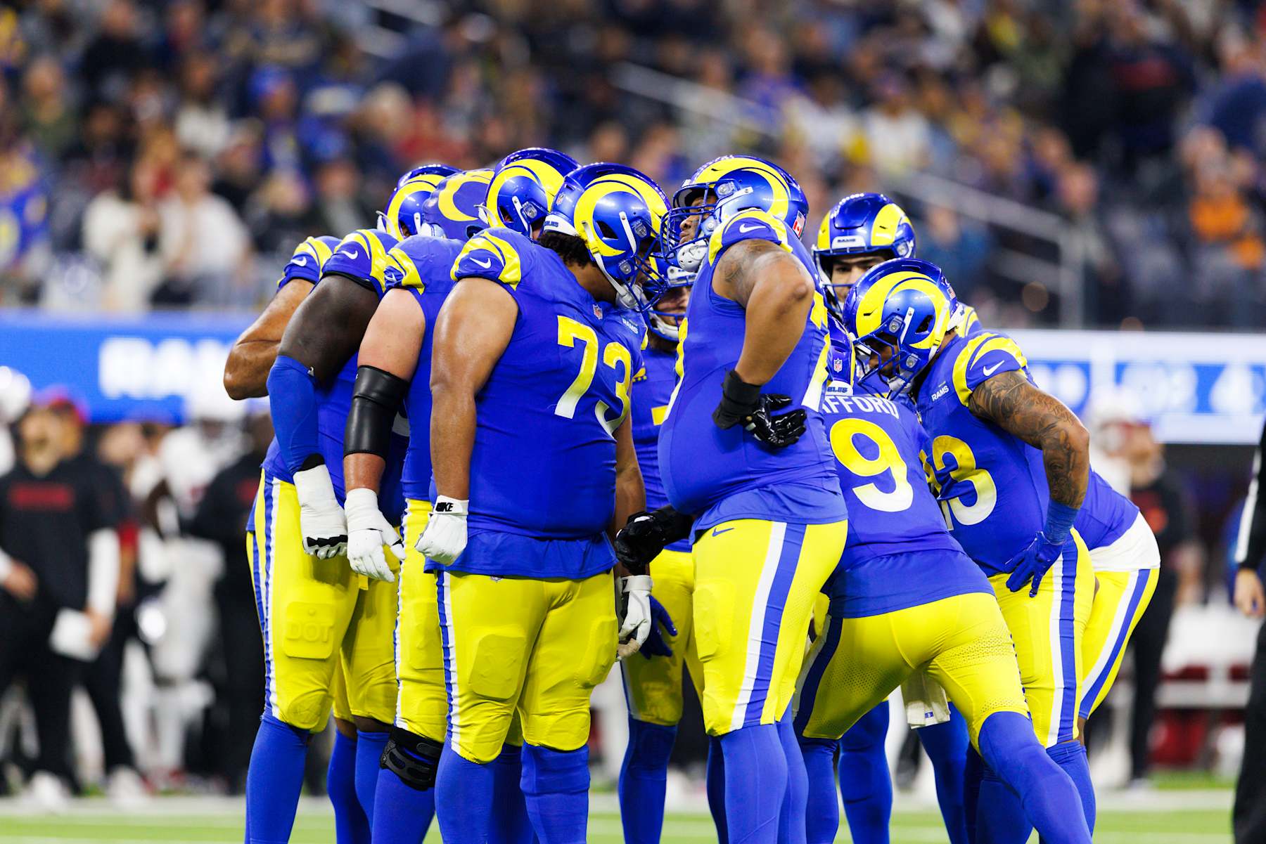 INGLEWOOD, CALIFORNIA - DECEMBER 28: Los Angeles Rams offensive unit group huddle during the first half against the Arizona Cardinals at SoFi Stadium on December 28, 2024 in Inglewood, California. (Photo by Ric Tapia/Getty Images)