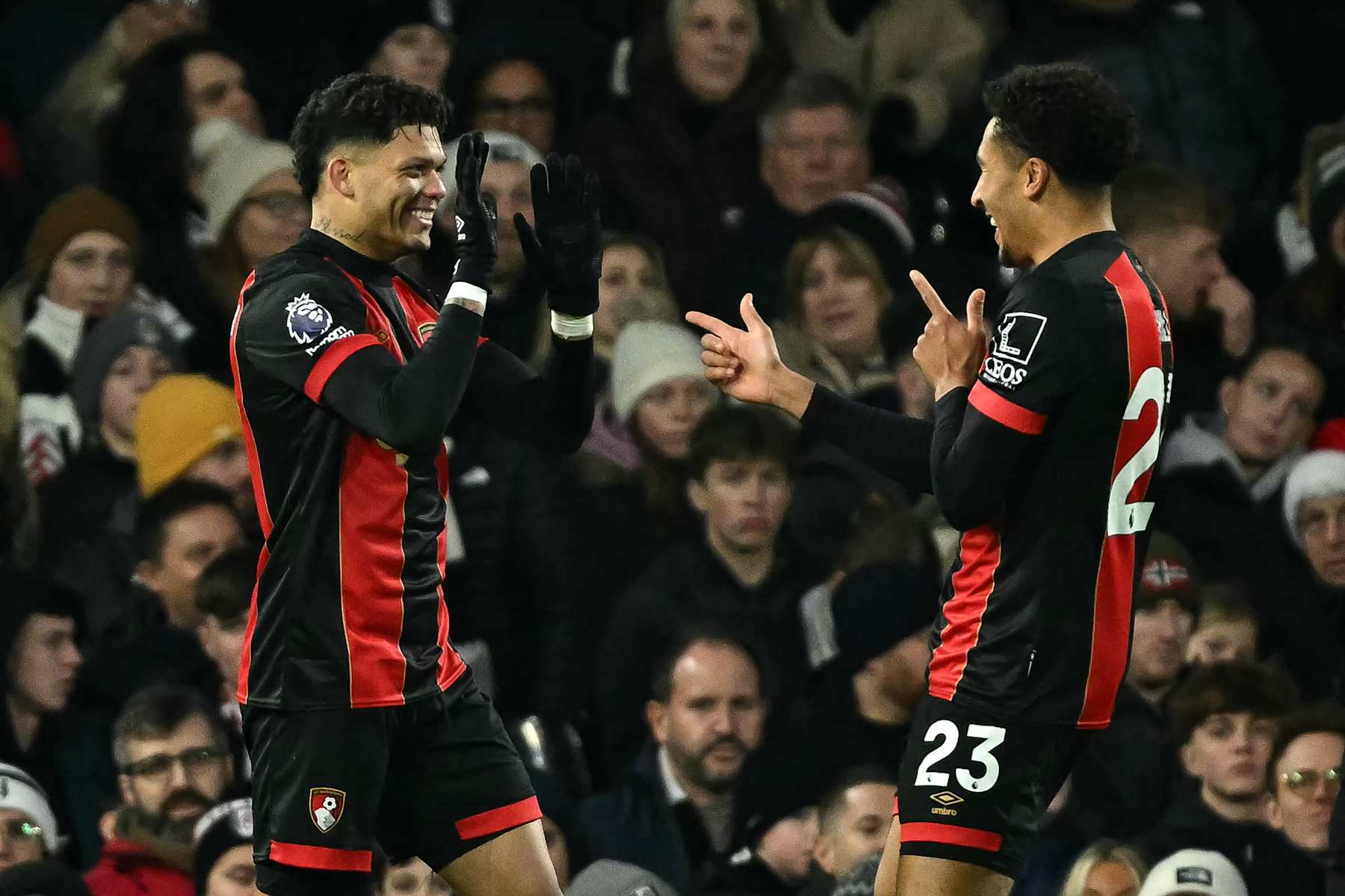 Bournemouth's Brazilian striker #09 Evanilson celebrates after scoring the equalising goal with Bournemouth's English defender #23 James Hill (R) during the English Premier League football match between Fulham and Bournemouth at Craven Cottage in London on December 29, 2024. (Photo by JUSTIN TALLIS / AFP) / RESTRICTED TO EDITORIAL USE. No use with unauthorized audio, video, data, fixture lists, club/league logos or 'live' services. Online in-match use limited to 120 images. An additional 40 images may be used in extra time. No video emulation. Social media in-match use limited to 120 images. An additional 40 images may be used in extra time. No use in betting publications, games or single club/league/player publications. / (Photo by JUSTIN TALLIS/AFP via Getty Images)