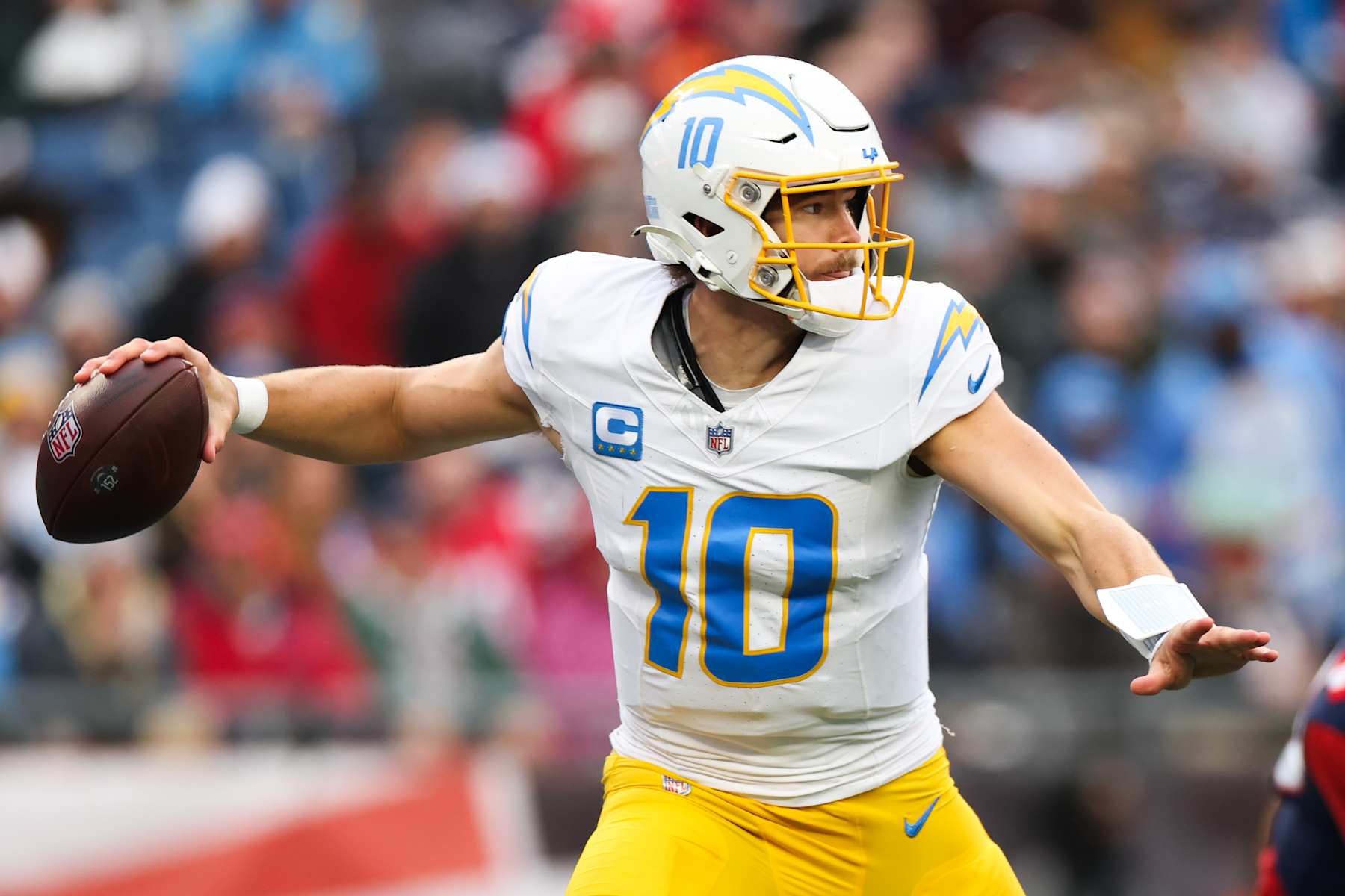 FOXBOROUGH, MASSACHUSETTS - DECEMBER 28: Justin Herbert #10 of the Los Angeles Chargers looks to throw the football during the third quarter against the New England Patriots at Gillette Stadium on December 28, 2024 in Foxborough, Massachusetts. (Photo by Kathryn Riley/Getty Images)