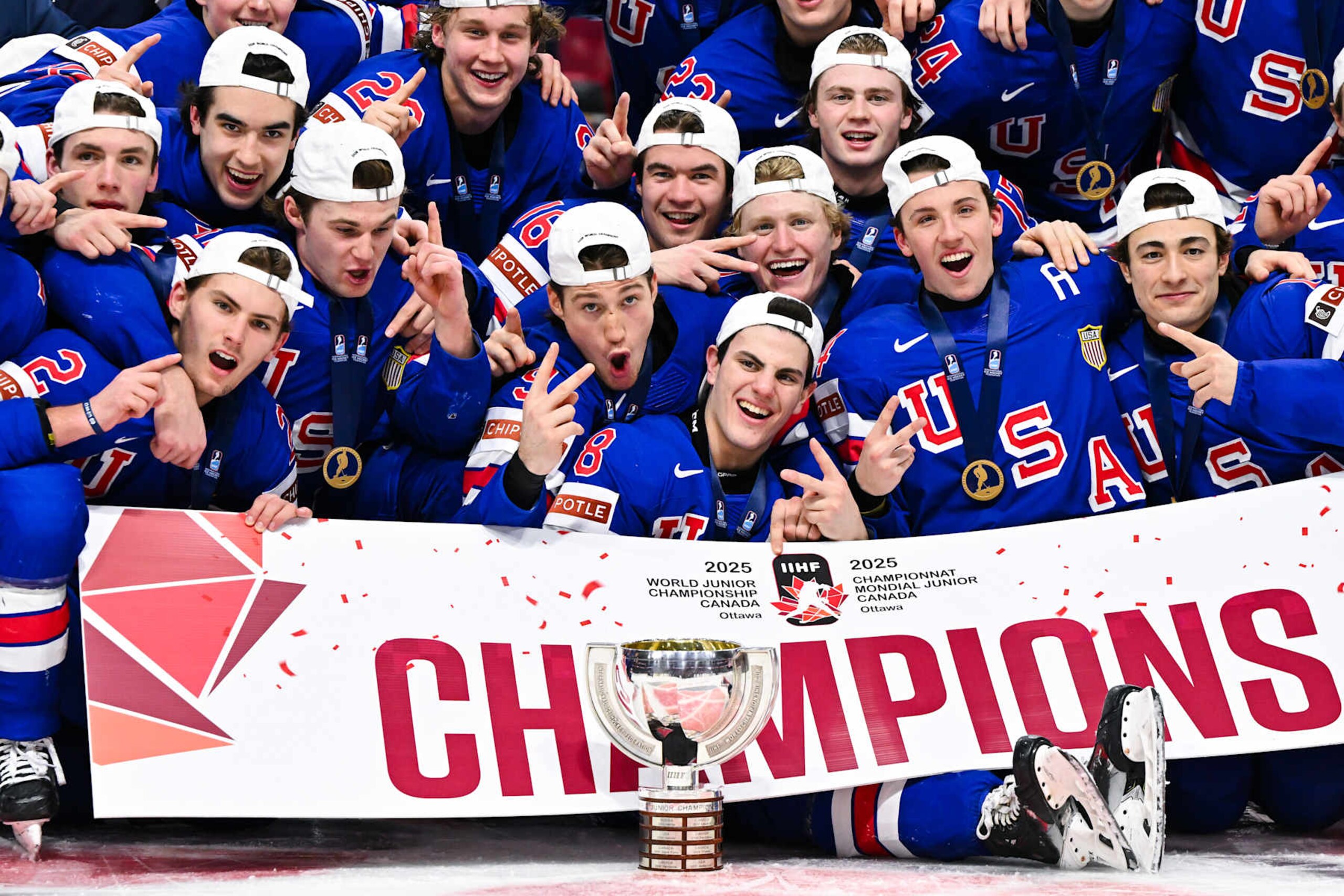 OTTAWA, CANADA - JANUARY 05:  Team USA pose with the IIHF Cup after winning gold in overtime against Team Finland during the 2025 IIHF World Junior Championship at Canadian Tire Centre on January 5, 2025 in Ottawa, Ontario, Canada.  (Photo by Minas Panagiotakis/Getty Images)