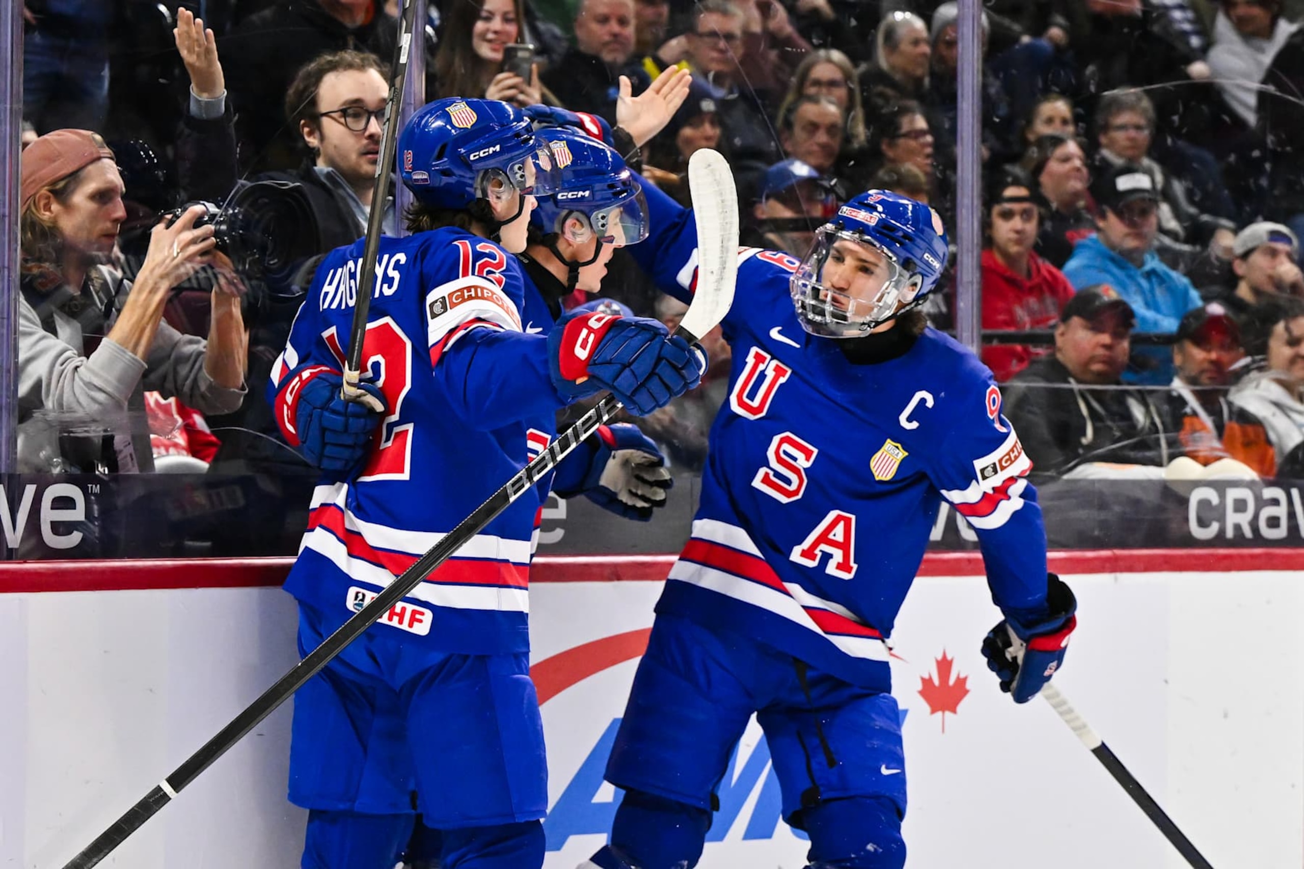 OTTAWA, CANADA - JANUARY 04:  Gabe Perreault #34 of Team USA celebrates his goal with teammates James Hagens #12 and Ryan Leonard #9 in the first period against Team Czechia of the semifinal match during the 2025 IIHF World Junior Championship at Canadian Tire Centre on January 4, 2025 in Ottawa, Ontario, Canada.  (Photo by Minas Panagiotakis/Getty Images)