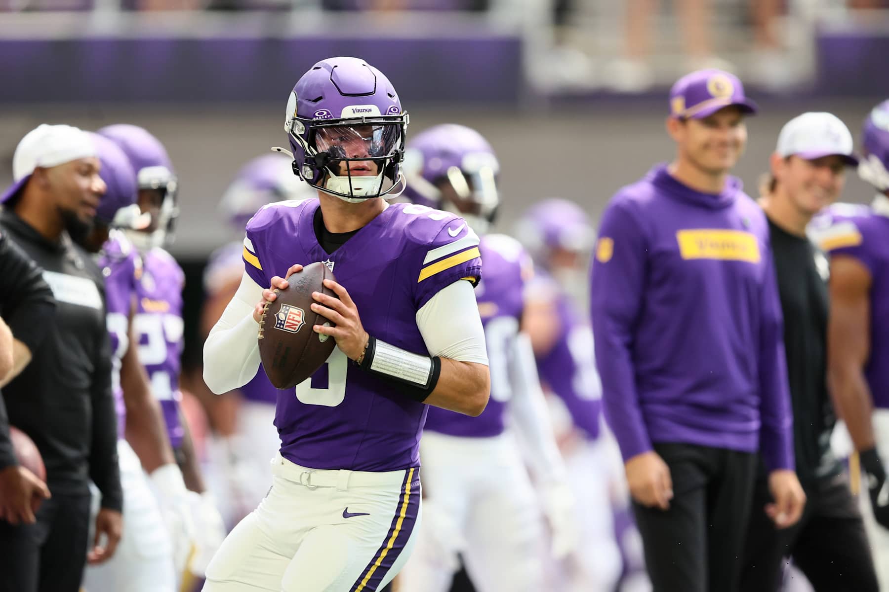 MINNEAPOLIS, MINNESOTA - AUGUST 10: Minnesota Vikings head coach Kevin OConnell watches J.J. McCarthy #9 of the Minnesota Vikings warm up before the pre-season game against Las Vegas Raiders at U.S. Bank Stadium on August 10, 2024 in Minneapolis, Minnesota. J.J. McCarthys season was cut short due to a knee injury in the preseason game. (Photo by Adam Bettcher/Getty Images)