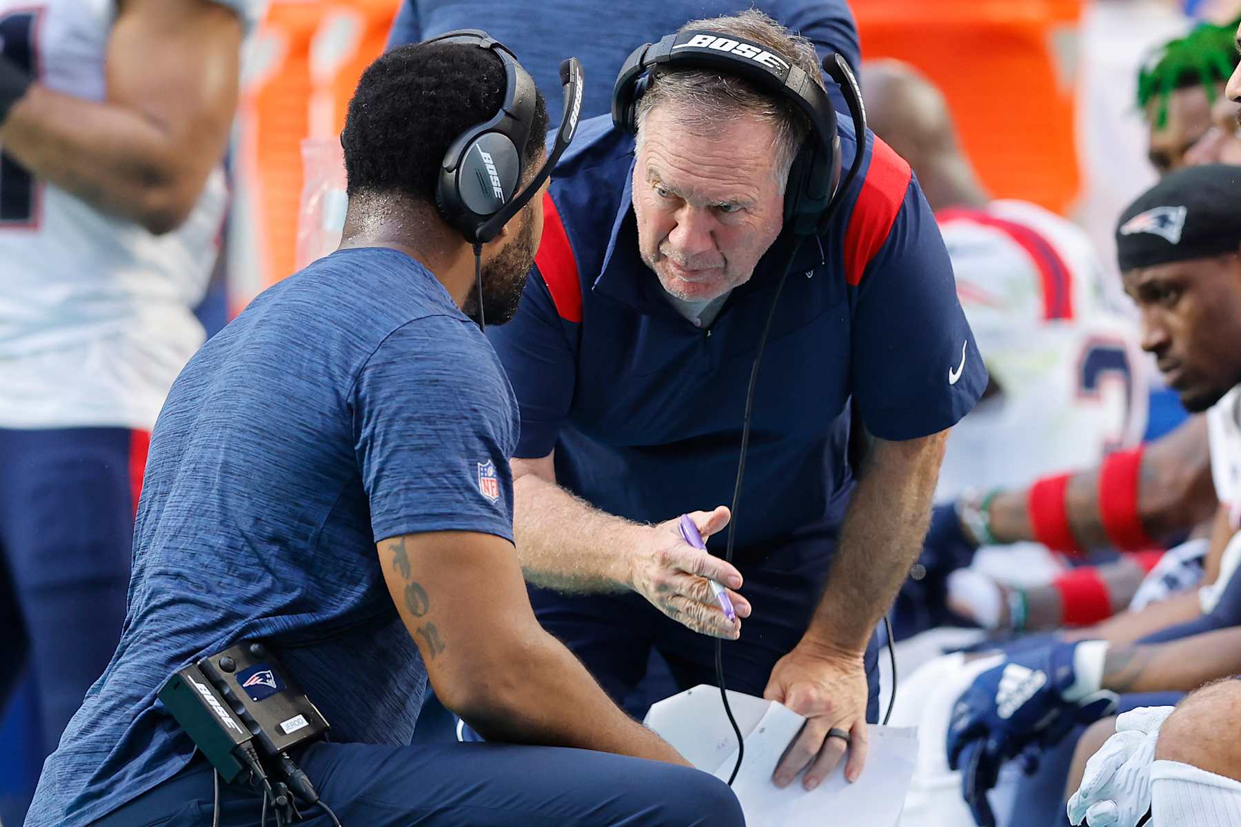 MIAMI GARDENS, FLORIDA - JANUARY 09: Head coach Bill Belichick and outside linebackers coach Jerod Mayo of the New England Patriots talk against the Miami Dolphins during the fourth quarter at Hard Rock Stadium on January 09, 2022 in Miami Gardens, Florida. (Photo by Michael Reaves/Getty Images)