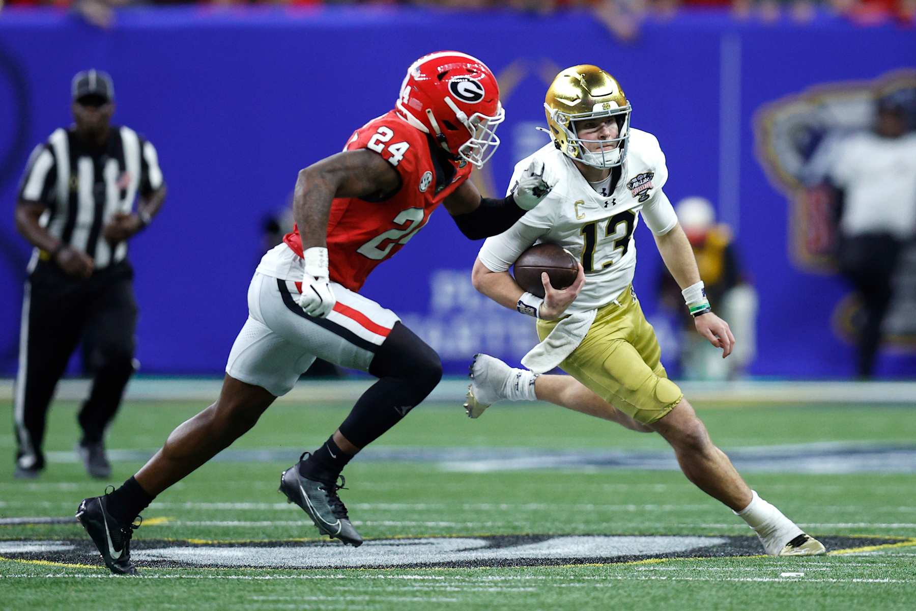 NEW ORLEANS, LOUISIANA - JANUARY 02: Riley Leonard #13 of the Notre Dame Fighting Irish carries the ball against Malaki Starks #24 of the Georgia Bulldogs during the third quarter during the 91st Allstate Sugar Bowl at Caesars Superdome on January 02, 2025 in New Orleans, Louisiana. (Photo by Sean Gardner/Getty Images)