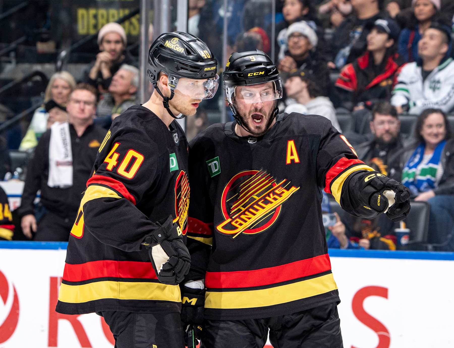 VANCOUVER, CANADA - DECEMBER 23: Elias Pettersson #40 and J.T. Miller #9 of the Vancouver Canucks discuss game play during the second period of their NHL game against the San Jose Sharks at Rogers Arena on December 23, 2024 in Vancouver, British Columbia, Canada. (Photo by Jeff Vinnick/NHLI via Getty Images)