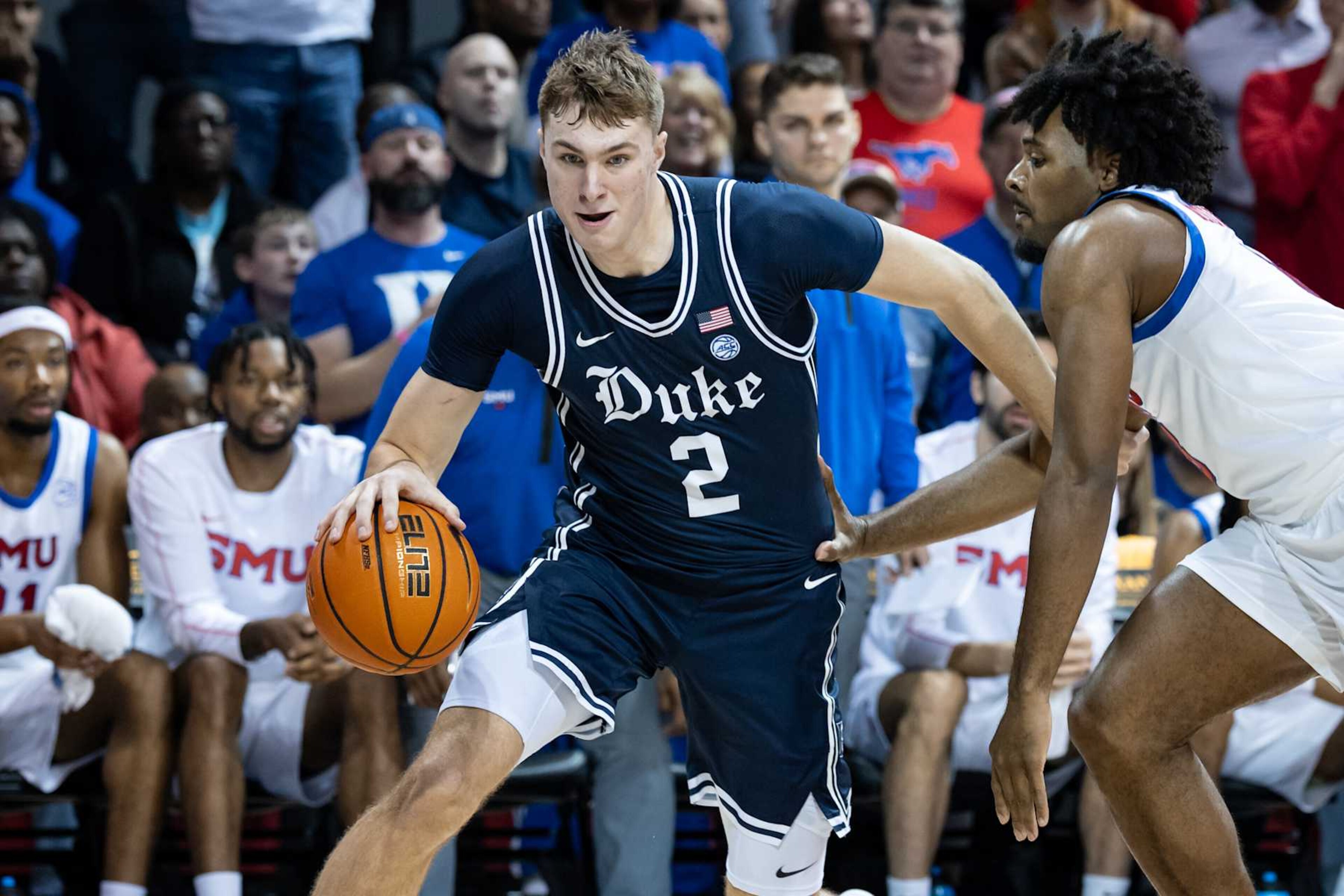DALLAS, TX - JANUARY 04: Duke Blue Devils forward Cooper Flagg (#2) dribbles past SMU Mustangs guard Kario Oquendo (#8) along the baseline during the college basketball game between the SMU Mustangs and the Duke Blue Devils on January 4, 2025, at Moody Coliseum in Dallas, TX. (Photo by Matthew Visinsky/Icon Sportswire via Getty Images) DALLAS, TX - JANUARY 04: Duke Blue Devils forward Cooper Flagg (#2) dribbles past SMU Mustangs guard Kario Oquendo (#8) along the baseline during the college basketball game between the SMU Mustangs and the Duke Blue Devils on January 4, 2025, at Moody Coliseum in Dallas, TX. (Photo by Matthew Visinsky/Icon Sportswire via Getty Images)
