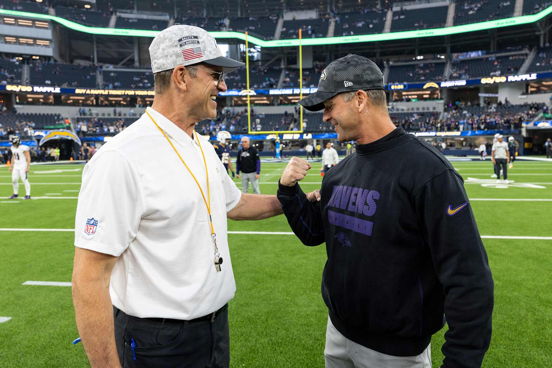 INGLEWOOD, CALIFORINA - NOVEMBER 25: Head coach Jim Harbaugh of the Los Angeles and Head coach John Harbaugh of the Baltimore Ravens share a moment prior to an NFL Football game at SoFi Stadium on November 25, 2024 in Inglewood, Califorina. (Photo by Michael Owens/Getty Images)