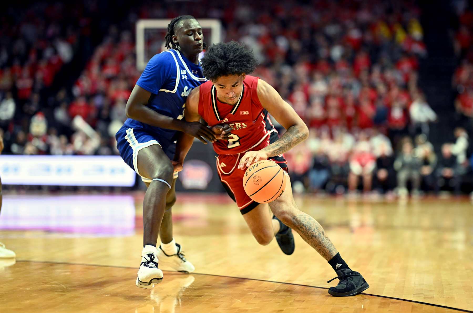 PISCATAWAY, NEW JERSEY - DECEMBER 14: Dylan Harper #2 of the Rutgers Scarlet Knights handles the ball against Garwey Dual #33 of the Seton Hall Pirates in the Garden State Hardwood Classic at Jersey Mike's Arena on December 14, 2024 in Piscataway, New Jersey. (Photo by G Fiume/Getty Images)